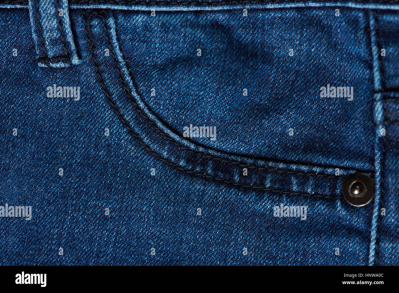 Close up of dark blue jeans pocket. Macro of jeans texture pocket Stock Photo