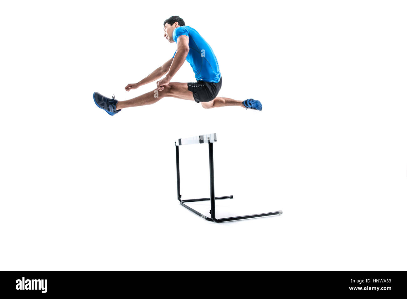 Male athlete jumping over obstacle Stock Photo