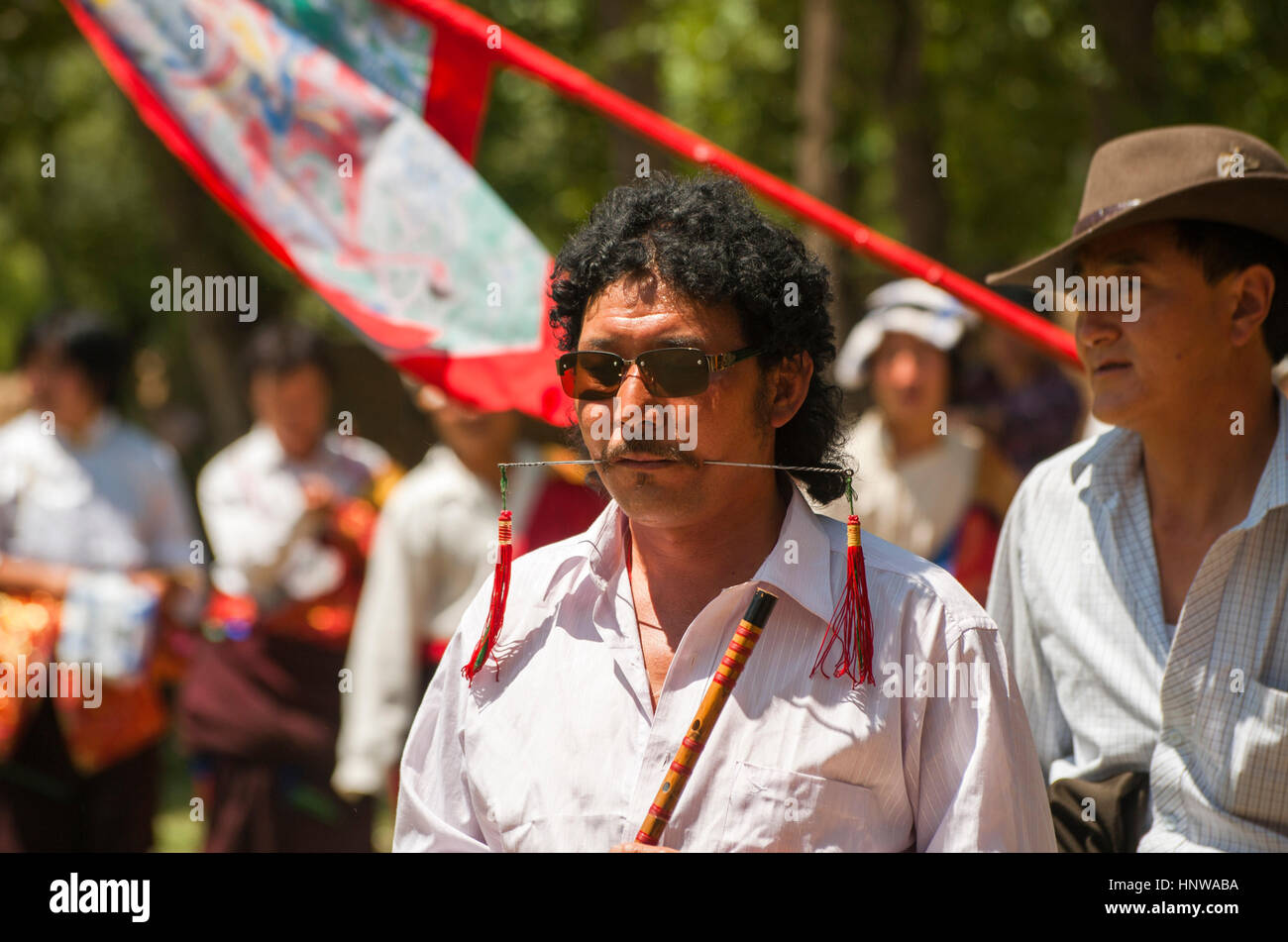 Man parades with  metal spike through cheeks as part of the Lurol Shaman Festival, Tongren , China Stock Photo