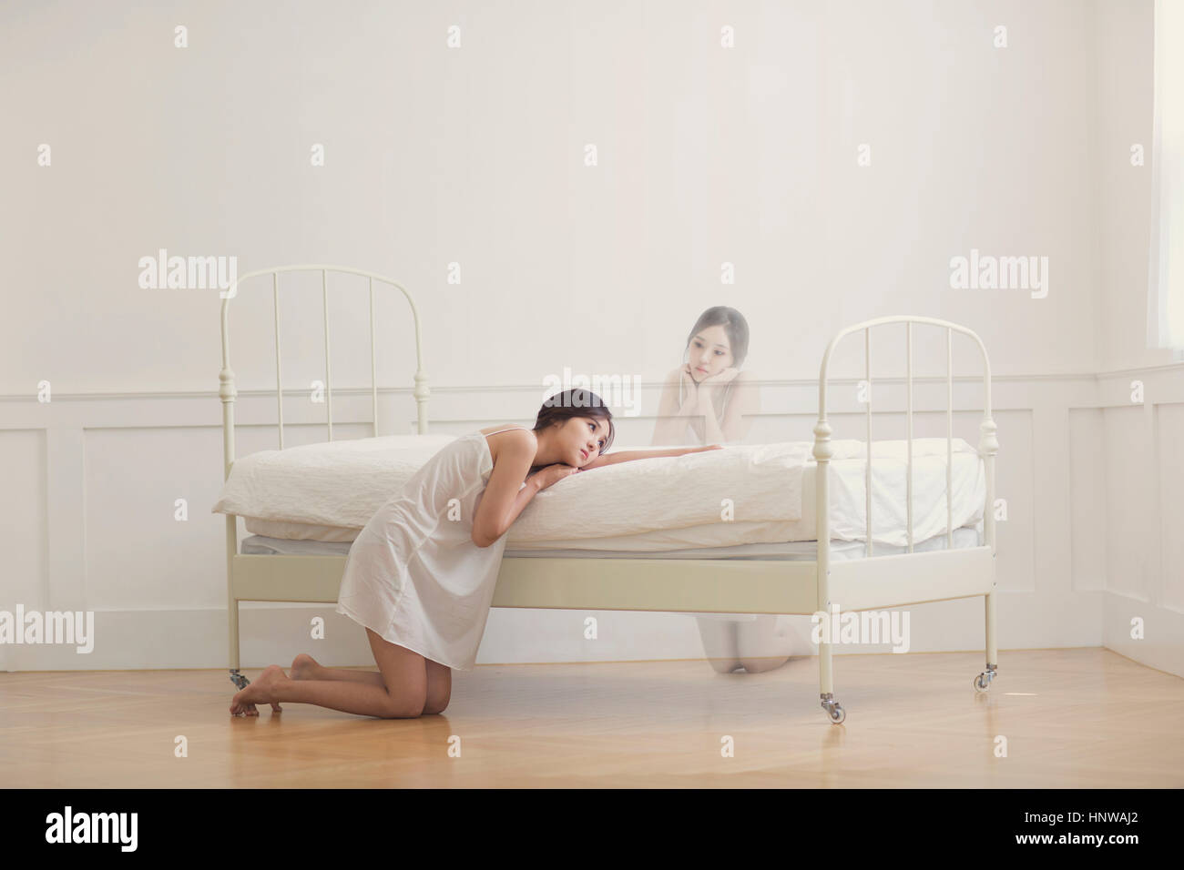 Woman depressed leaning on bed Stock Photo Alamy