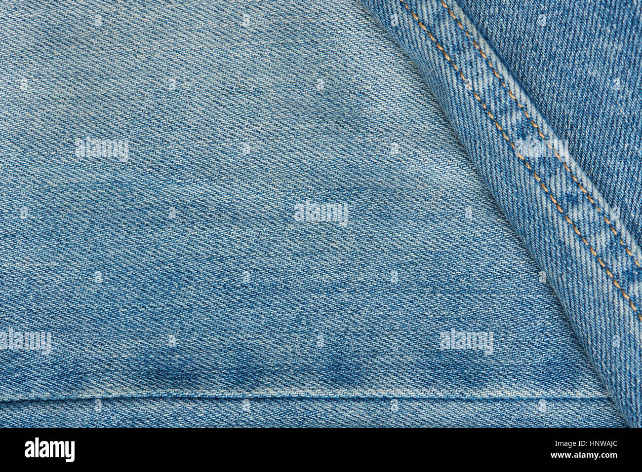 Texture of light jeans with stiches and threads background Stock Photo