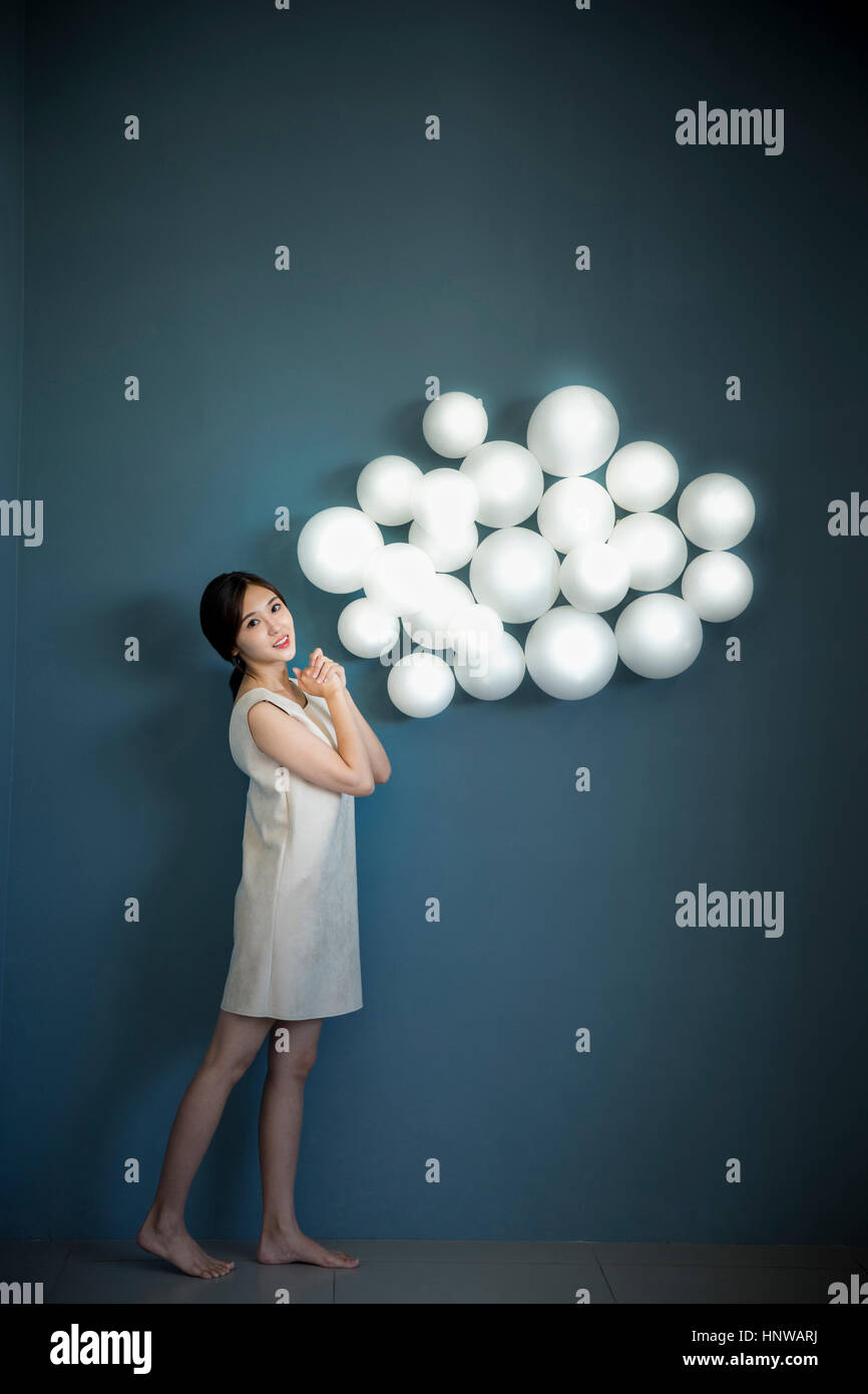 Young woman with white balloons Stock Photo