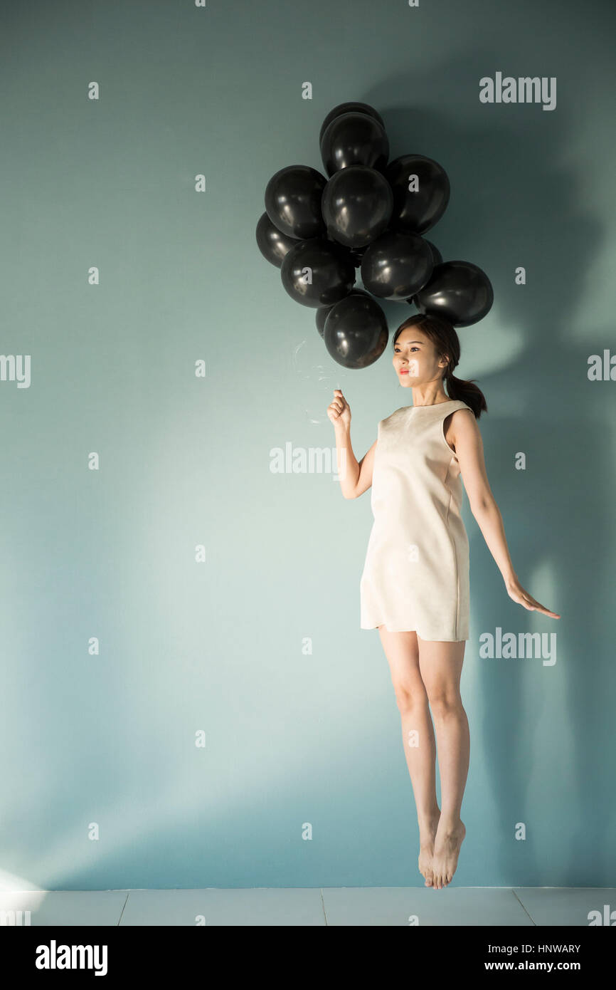Woman with balloons floating Stock Photo Alamy