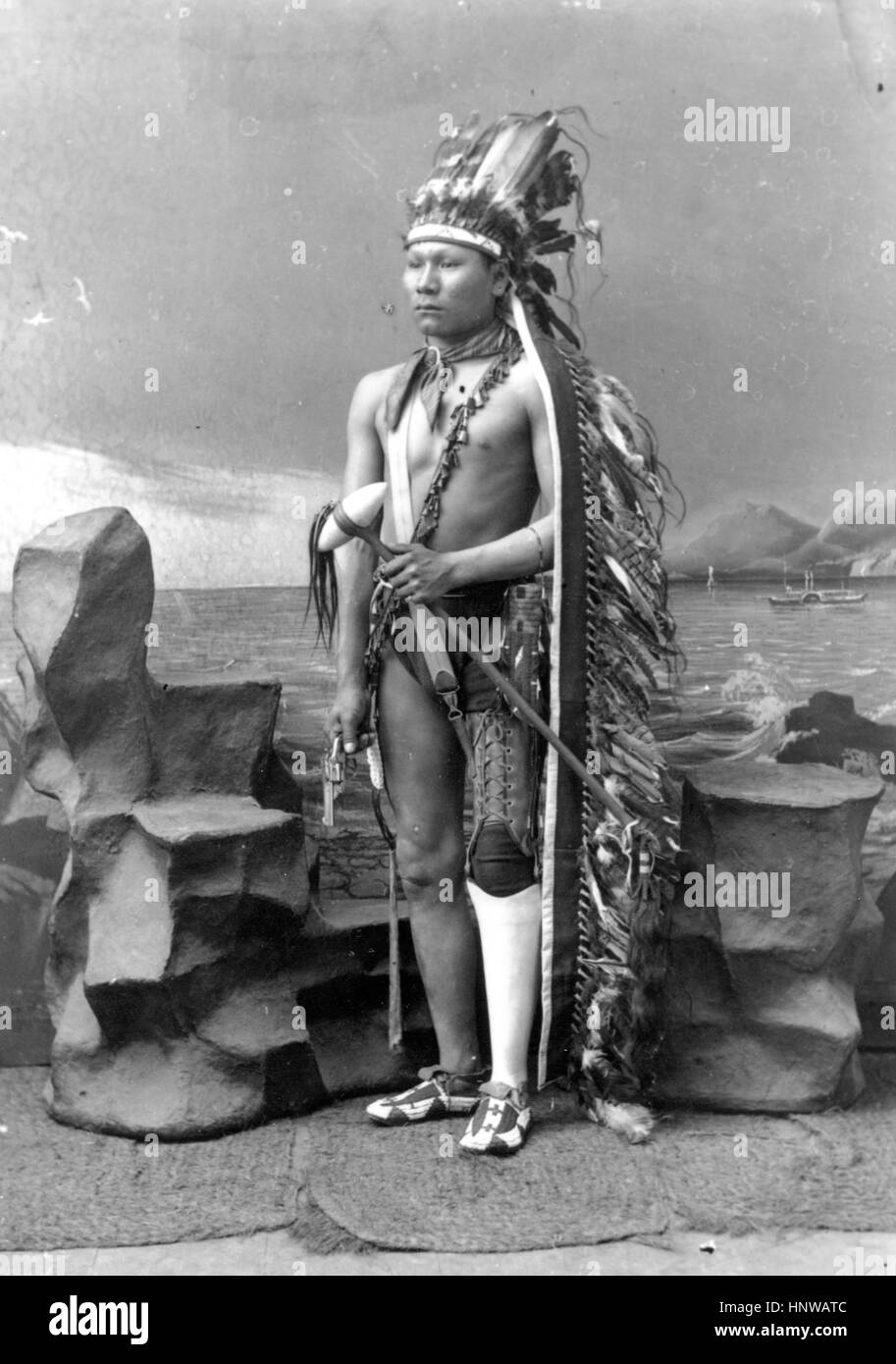 American Indian, Native American young man, wearing a Prosthetic leg.  Photo probably was taken in South Dakota. 1880s   Possible photographer - R.L. Kelly   To see my other weapon-related vintage images, Search:  Prestor  vintage  weapon  west Stock Photo