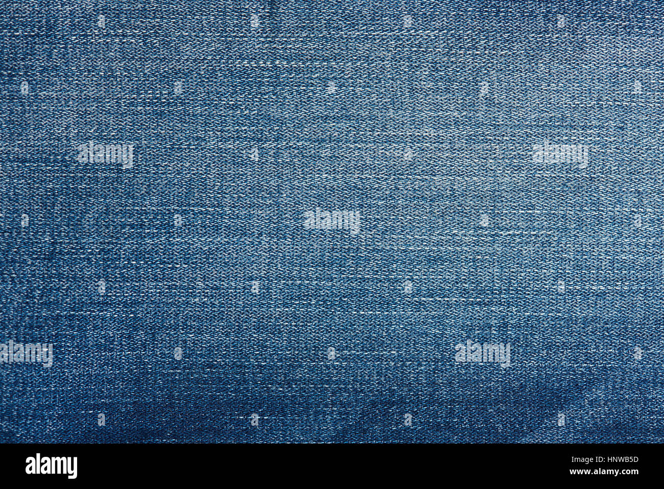 Jeans threads lines on blue background. Macro of jeans textile lines Stock Photo