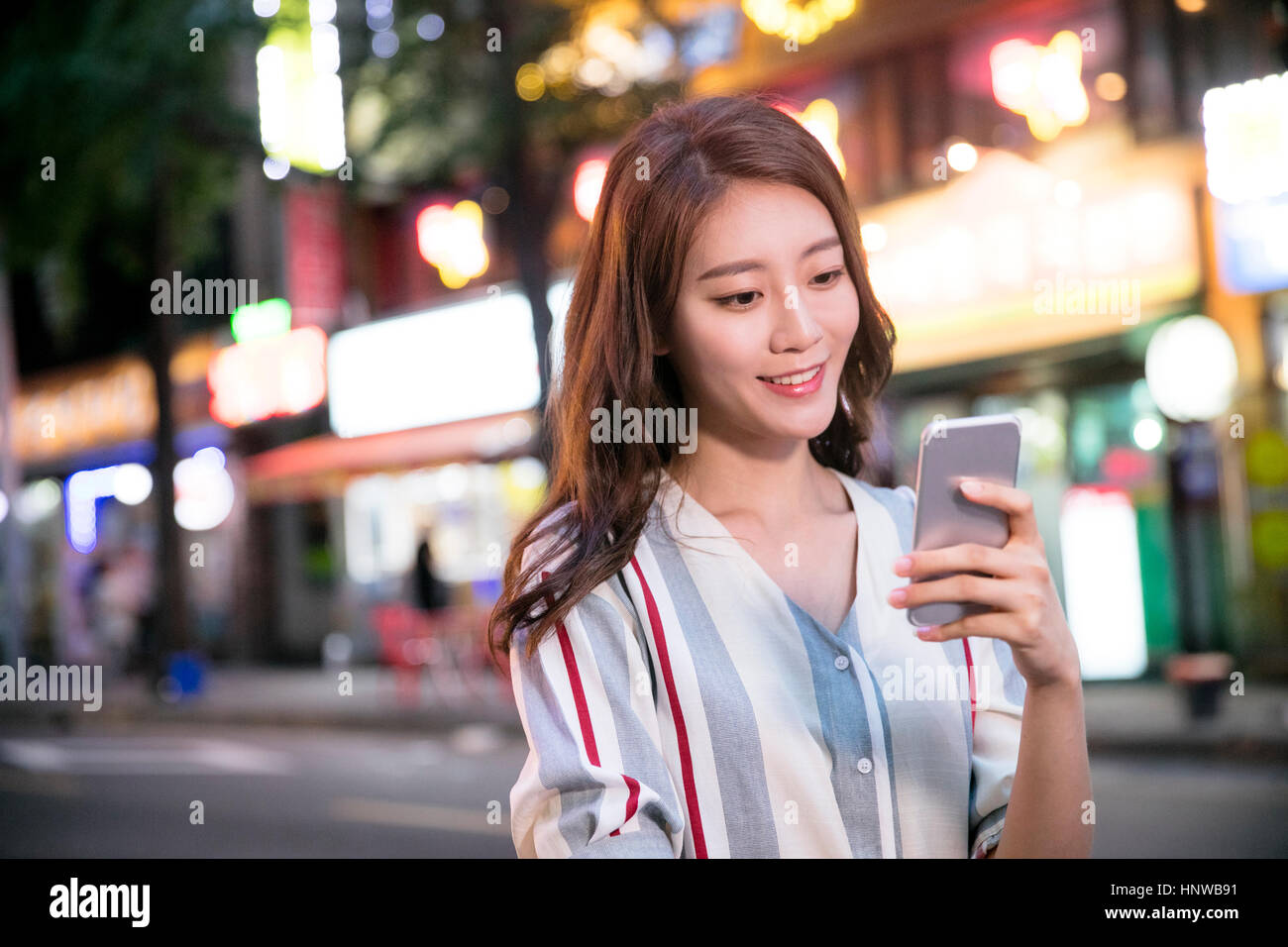 Portrait of young woman using cellphone Stock Photo