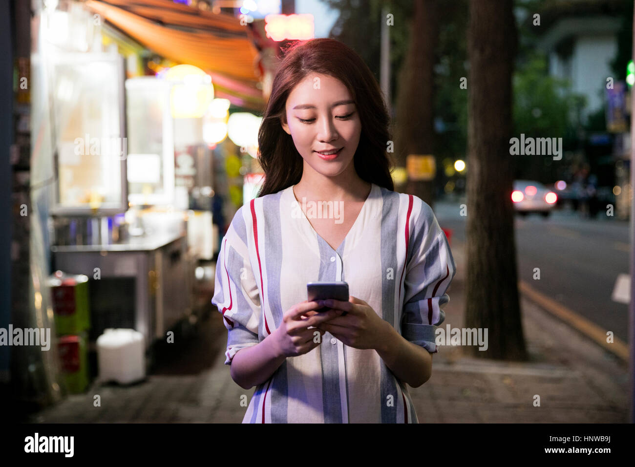 Young woman using cellphone Stock Photo
