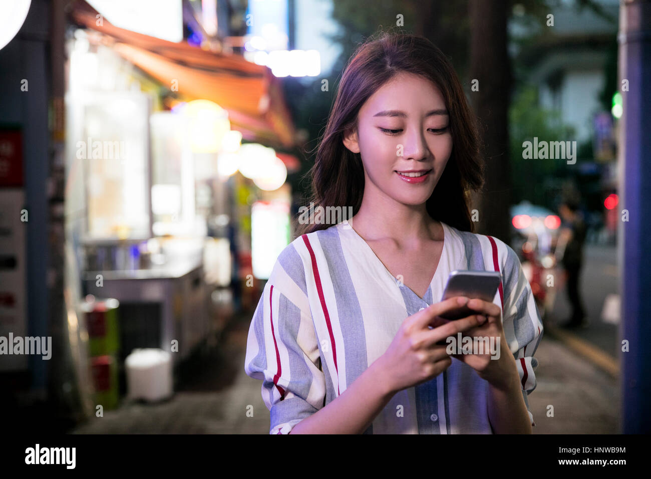 Young woman using cellphone Stock Photo