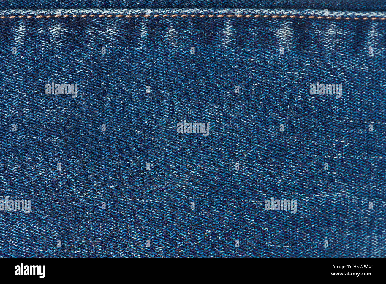Fabric jeans textile  with stitches. Texture of dark blue jeans Stock Photo