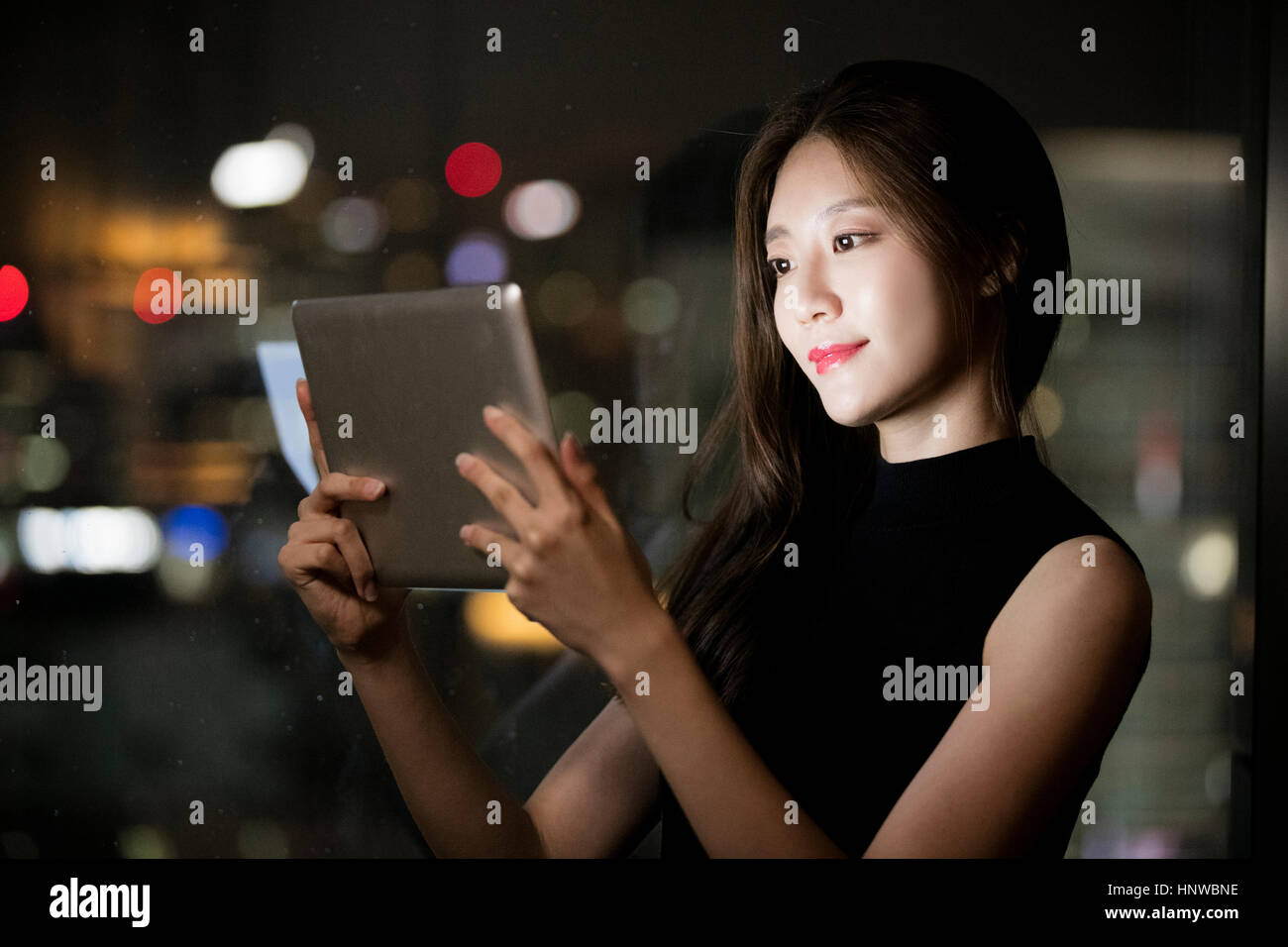Portrait of young woman using tablet Stock Photo