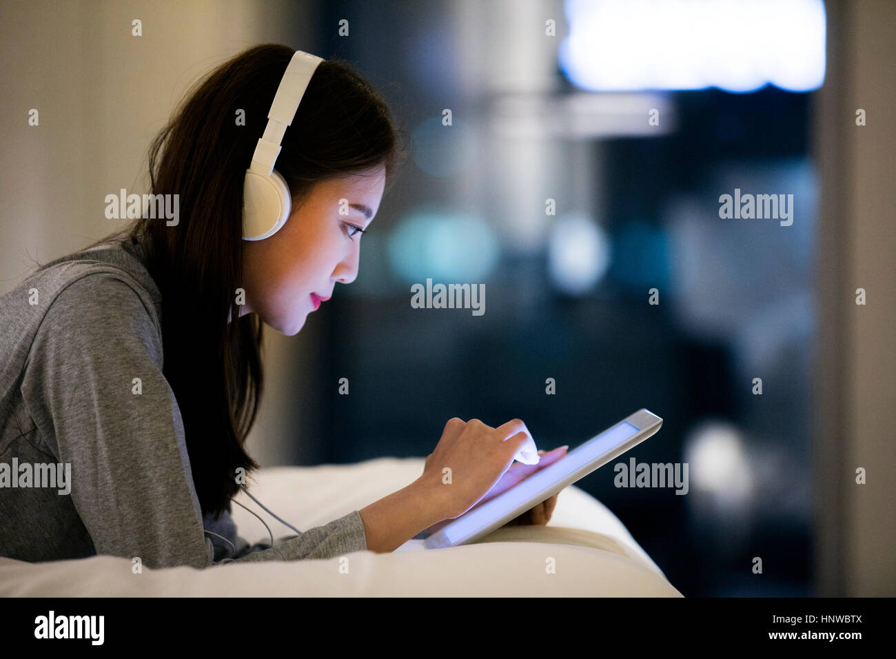 Woman using tablet at night Stock Photo