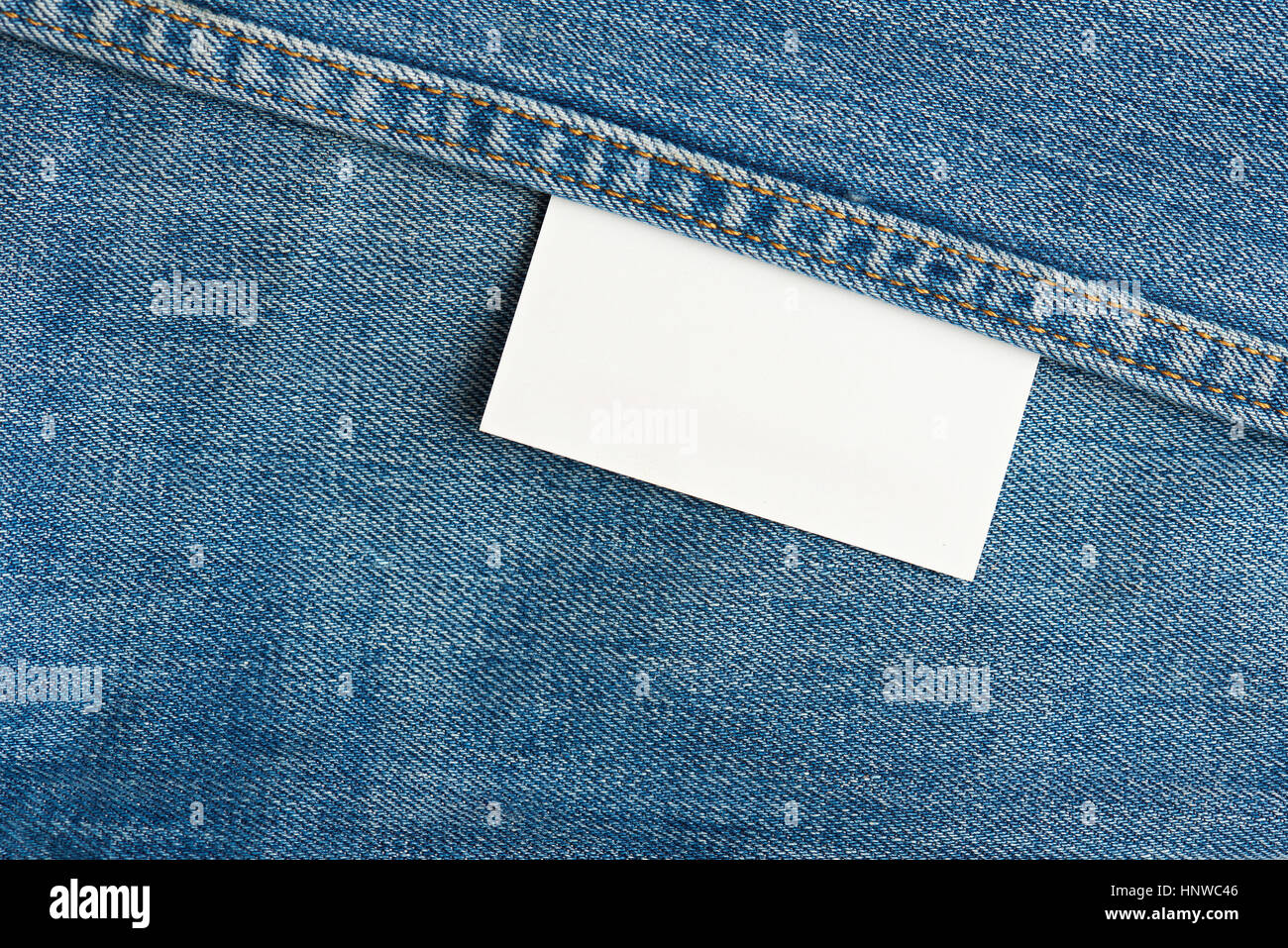 White rectangle tag on blue jeans background Stock Photo