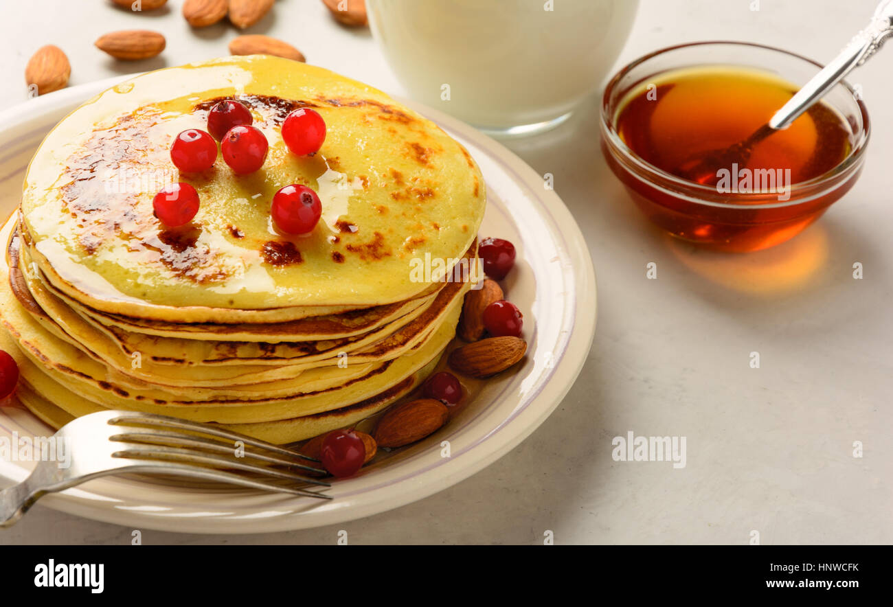 Pancakes with honey and almond on a white backgraund. Copy space. Stock Photo
