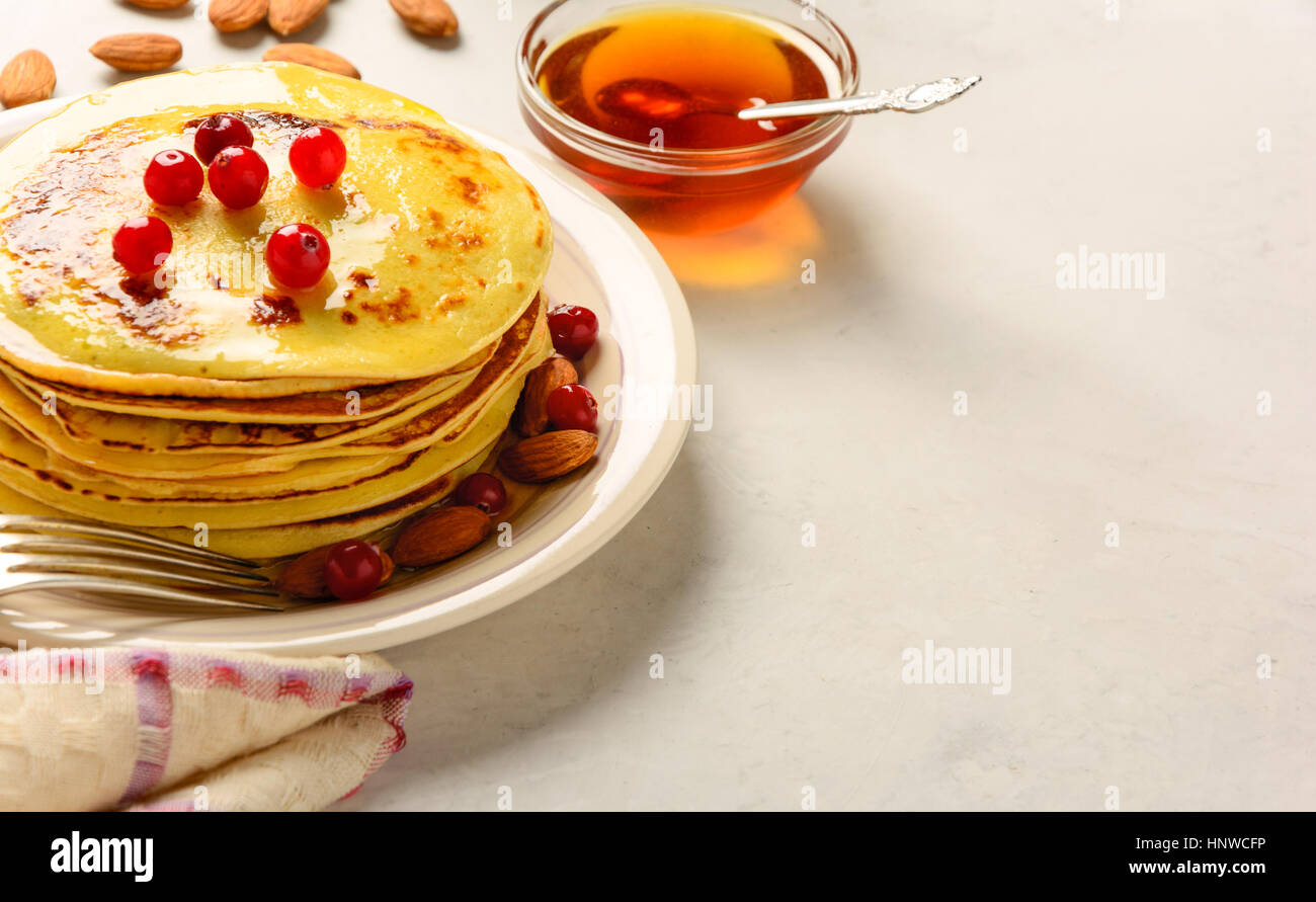 Pancakes with honey and almond on a white backgraund. Copy space. Stock Photo