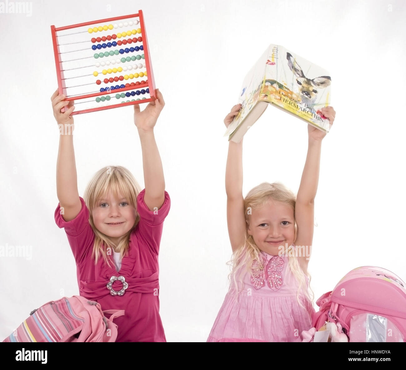 Model release, Zwei Schulmaedchen mit Lesebuch und Abakus - two schoolgirls with book and abacus Stock Photo