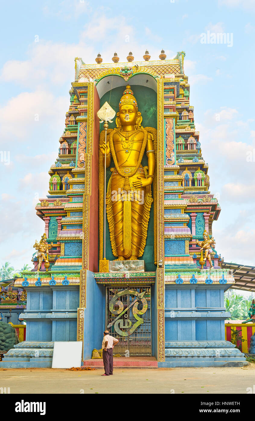 The giant golden statue of Murugan (Skanda), the Hindu God of War, at the entrance to the Murugan Kovil in Chilaw, Sri Lanka. Stock Photo