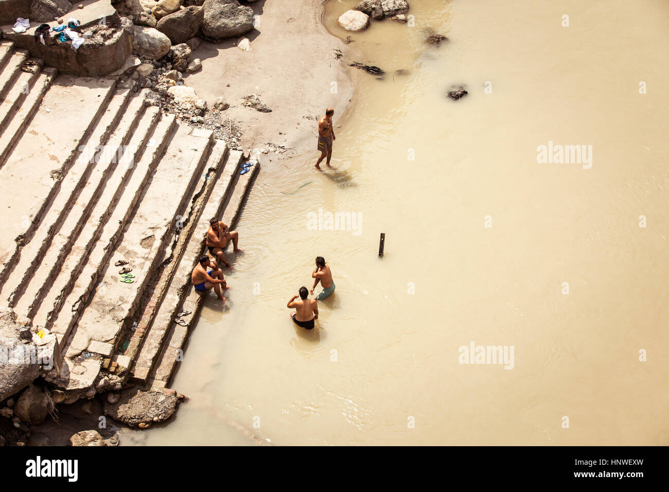 Rishikesh, India - September 22: Five indian men bathing in the Ganges river, Rishikesh, India on September 22, 2014. Stock Photo