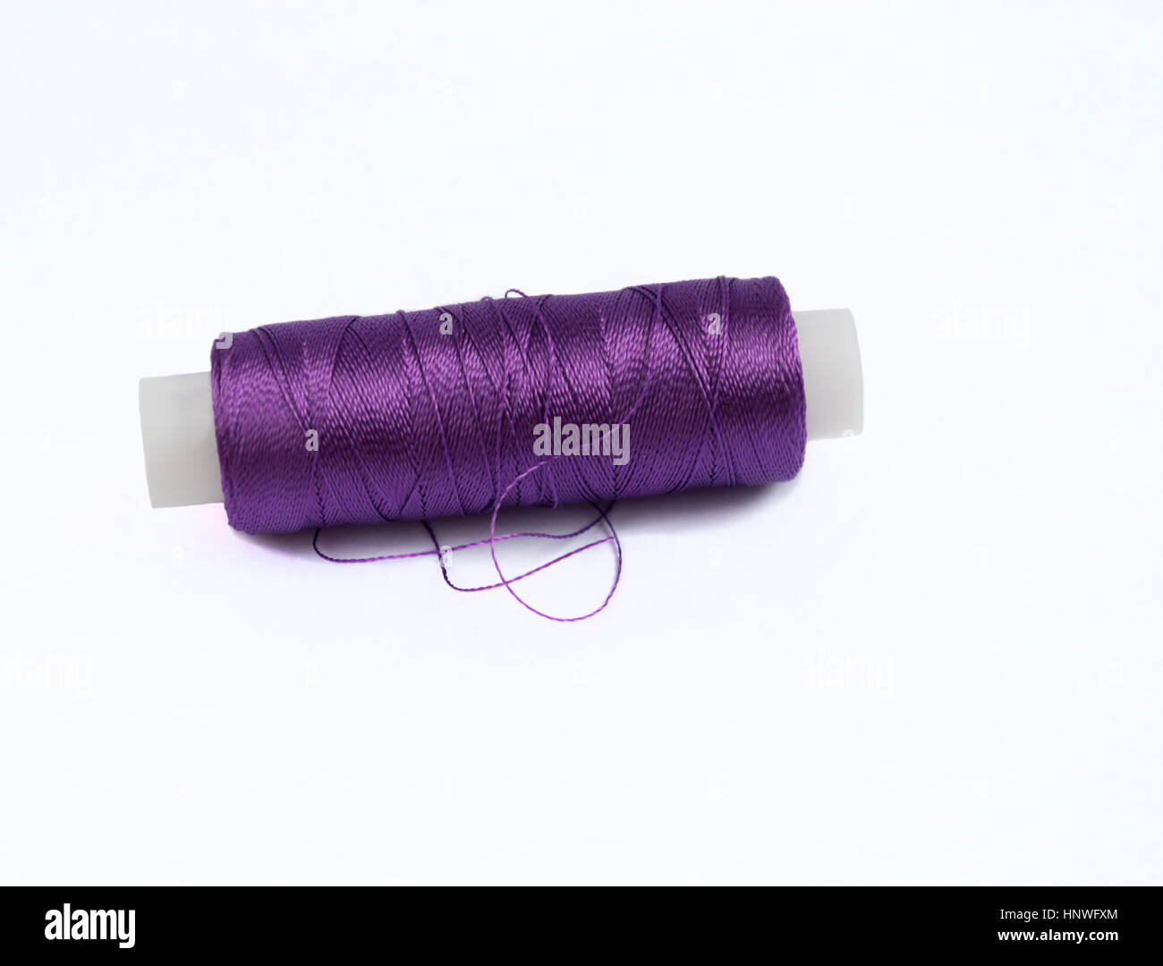 Purple spool of thread on the isolated background Stock Photo