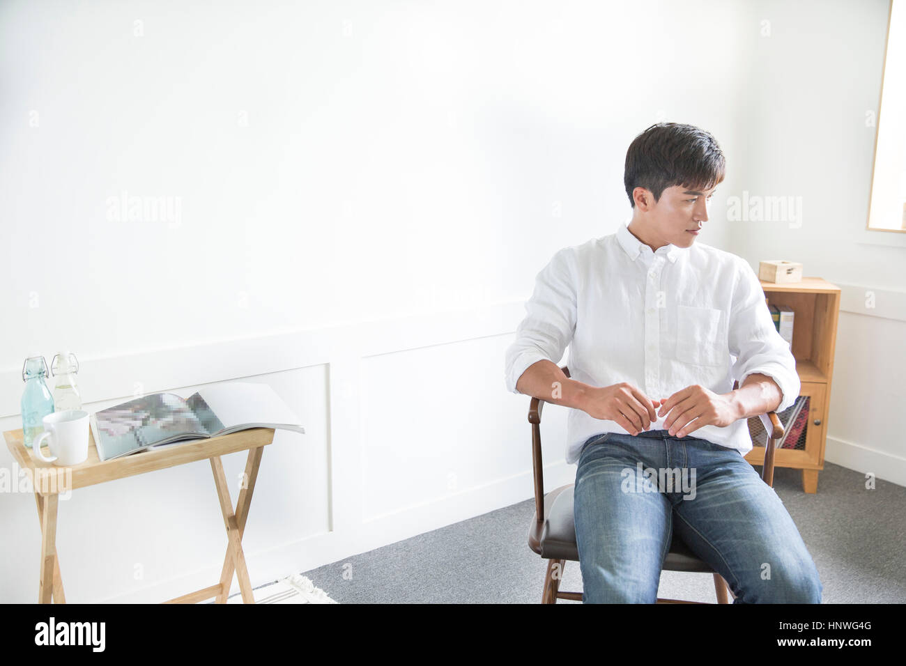 Smiling man sitting on chair Stock Photo