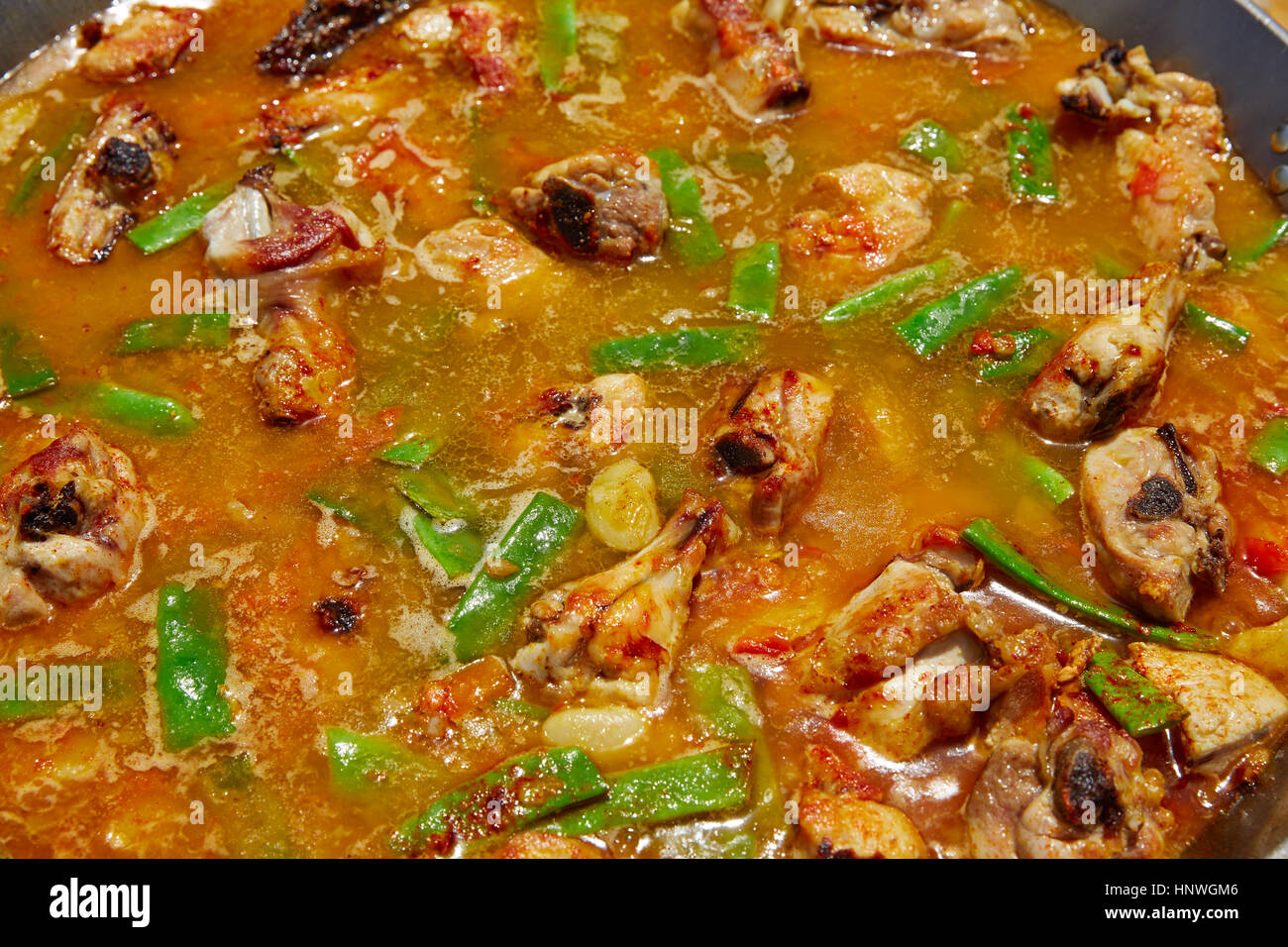 Paella from Spain recipe process ad water to get the broth boil Stock Photo