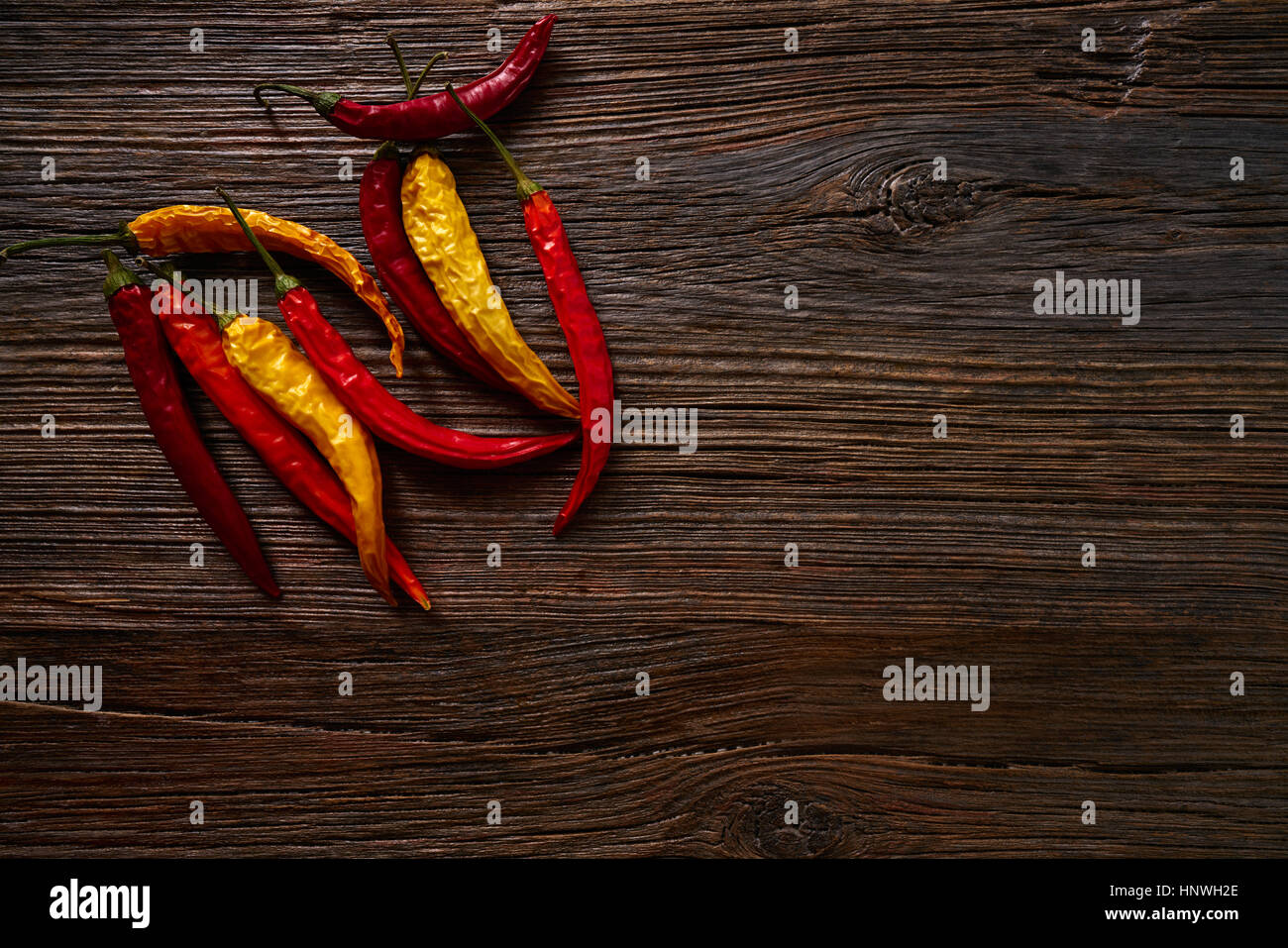 dried hot chili peppers on aged wood background Stock Photo - Alamy