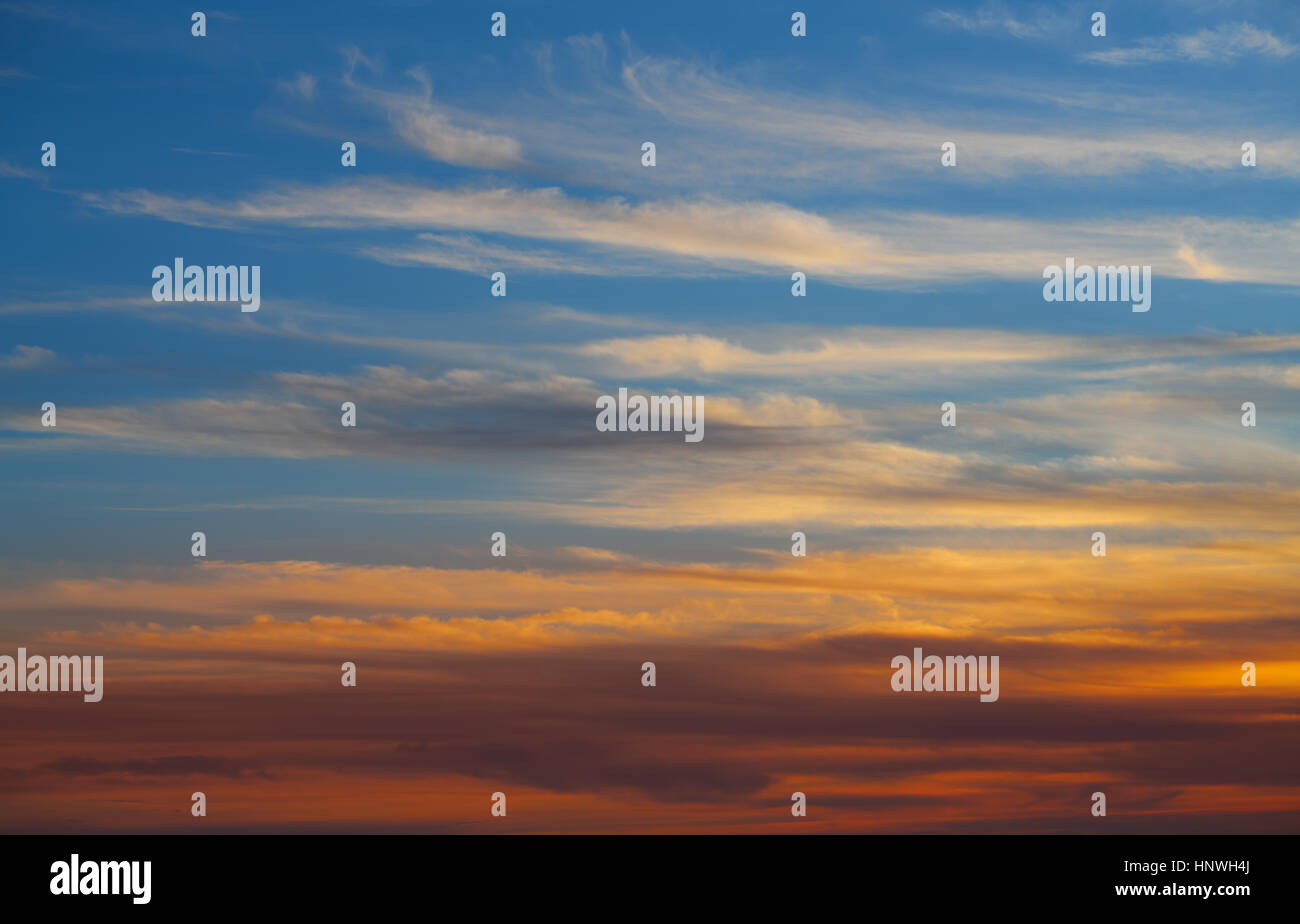 Sunset sky orange clouds over blue background Stock Photo - Alamy