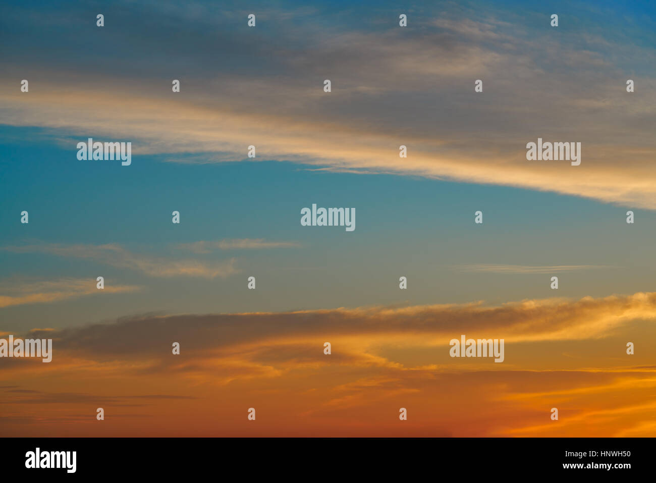 Sunset sky orange clouds over blue background Stock Photo - Alamy