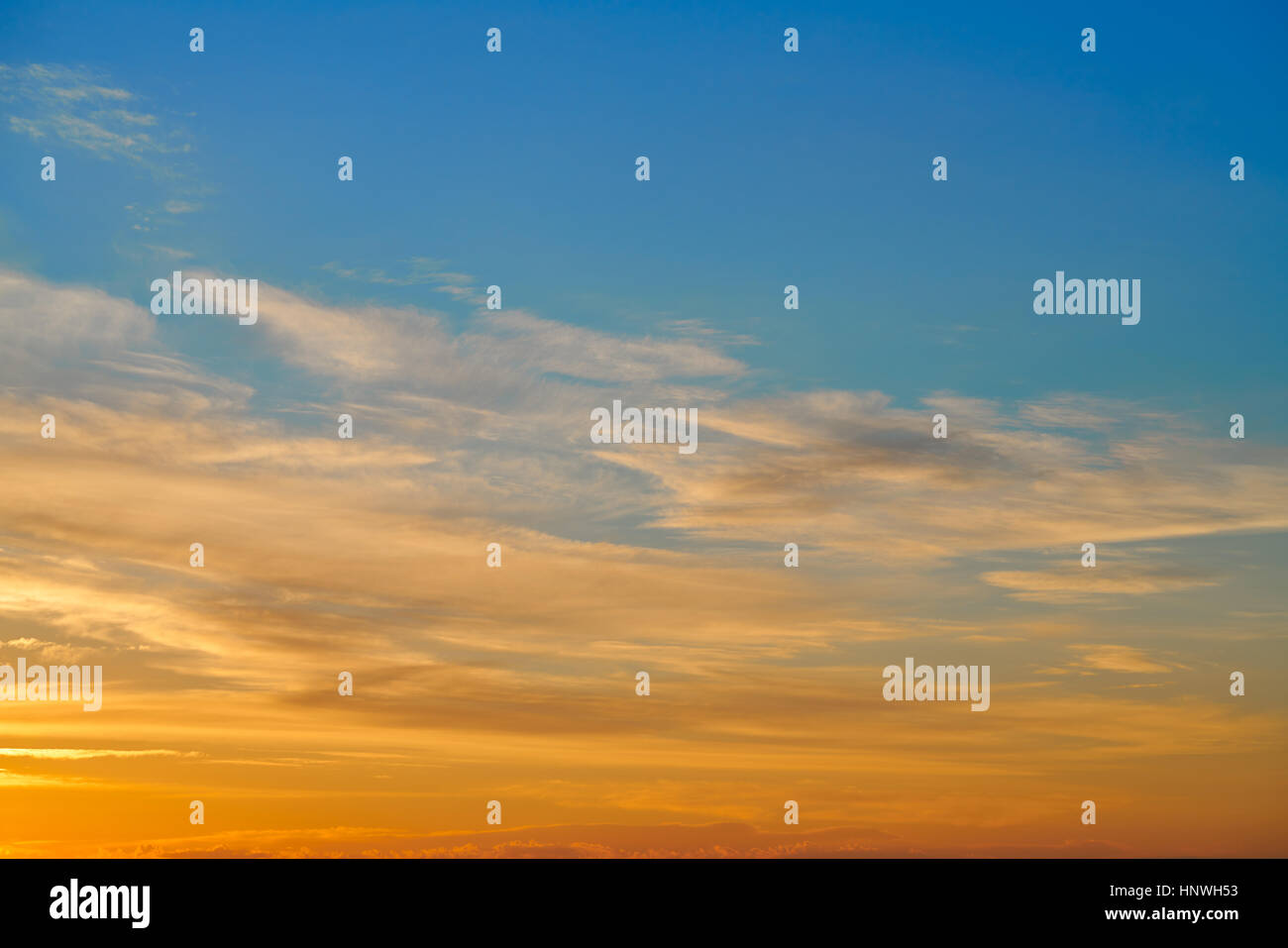 Sunset sky orange clouds over blue background Stock Photo - Alamy