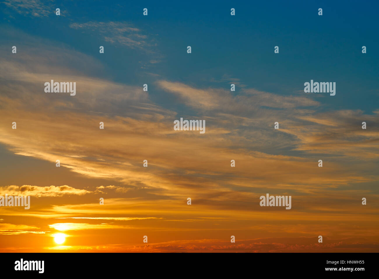 Sunset sky orange clouds over blue background Stock Photo - Alamy