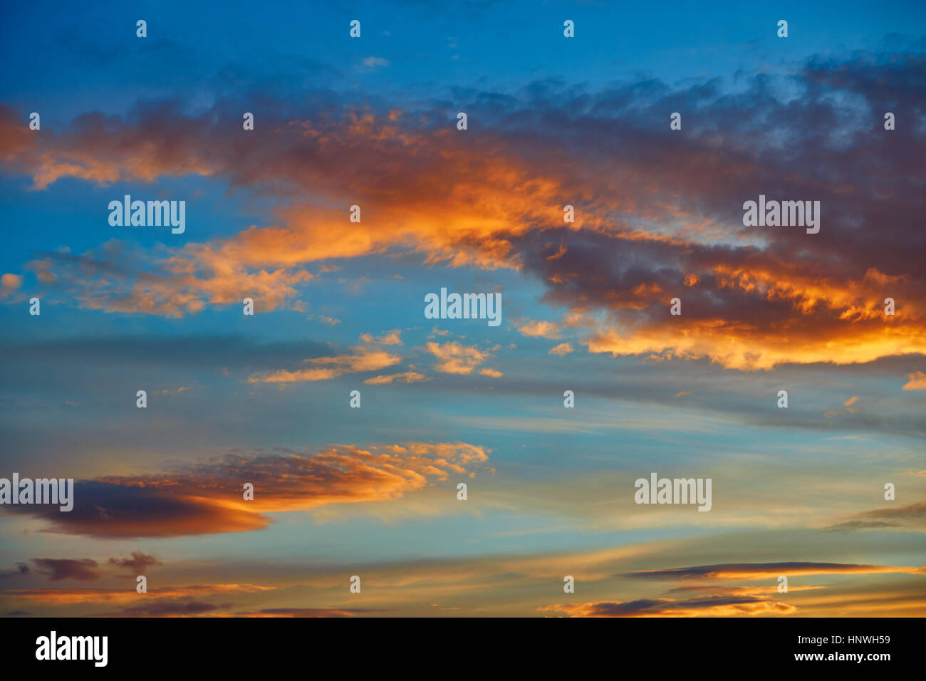 Sunset sky orange clouds over blue background Stock Photo - Alamy