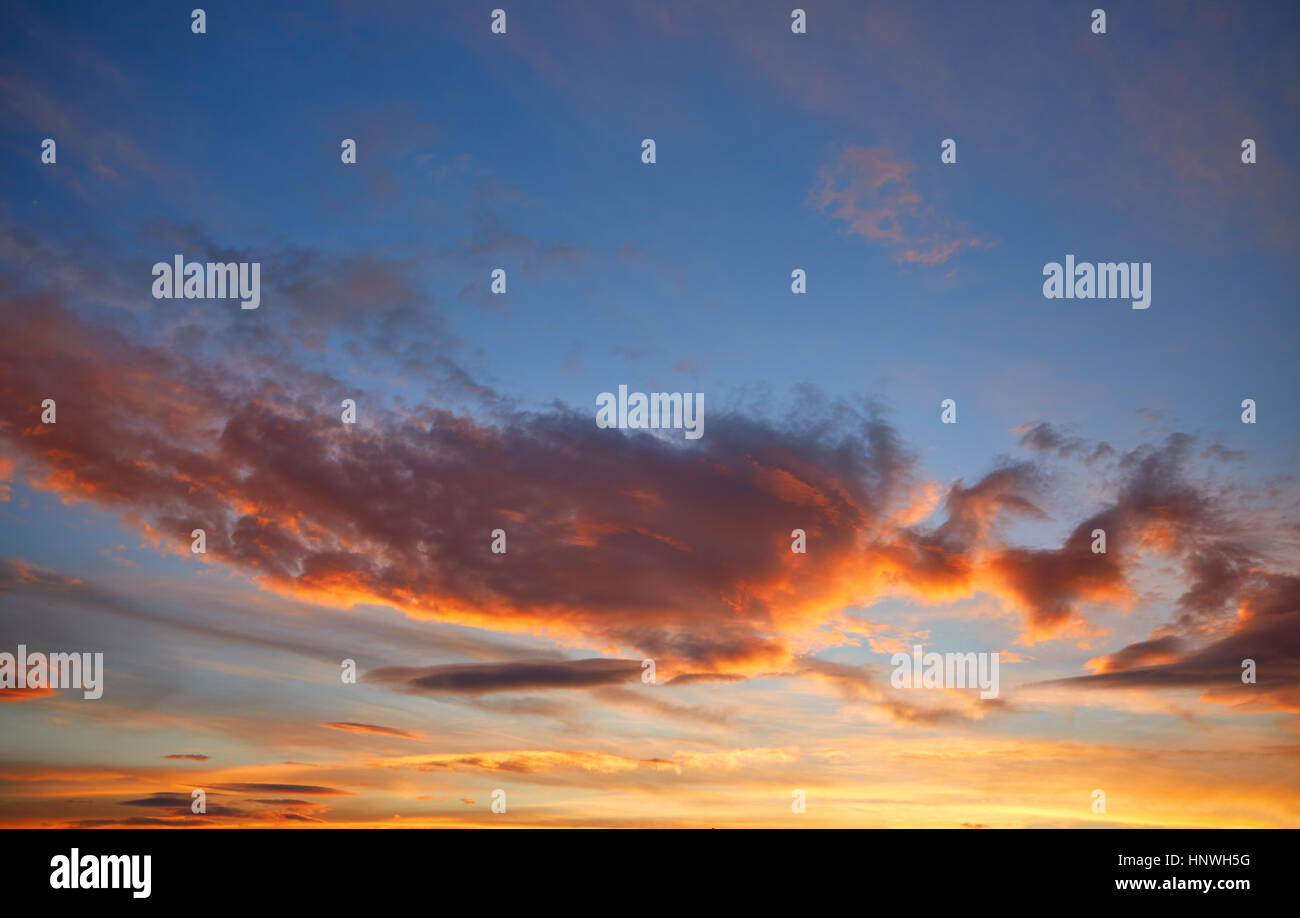 Sunset sky orange clouds over blue background Stock Photo - Alamy