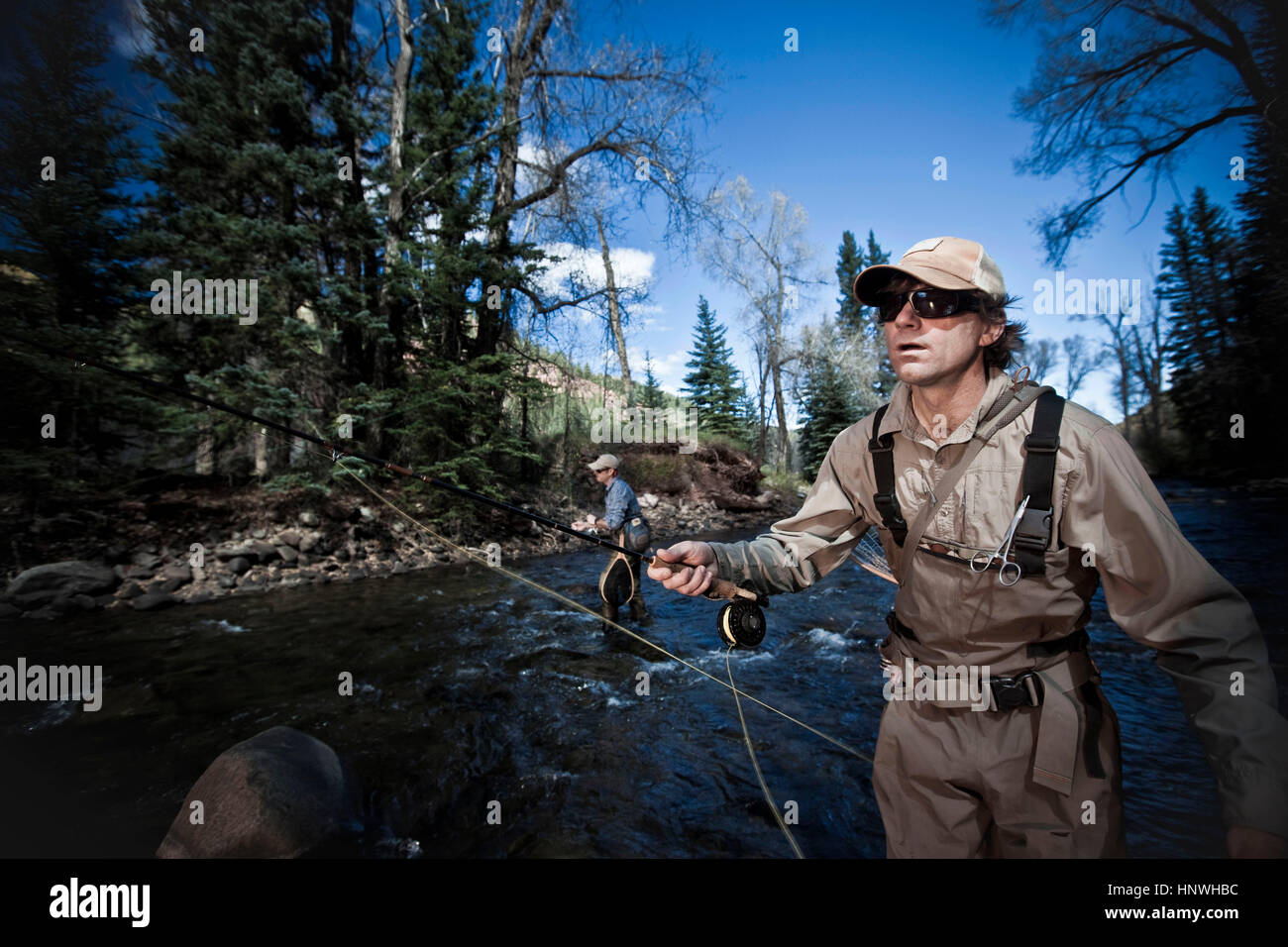 Fishermen in river fly fishing, Colorado, USA Stock Photo