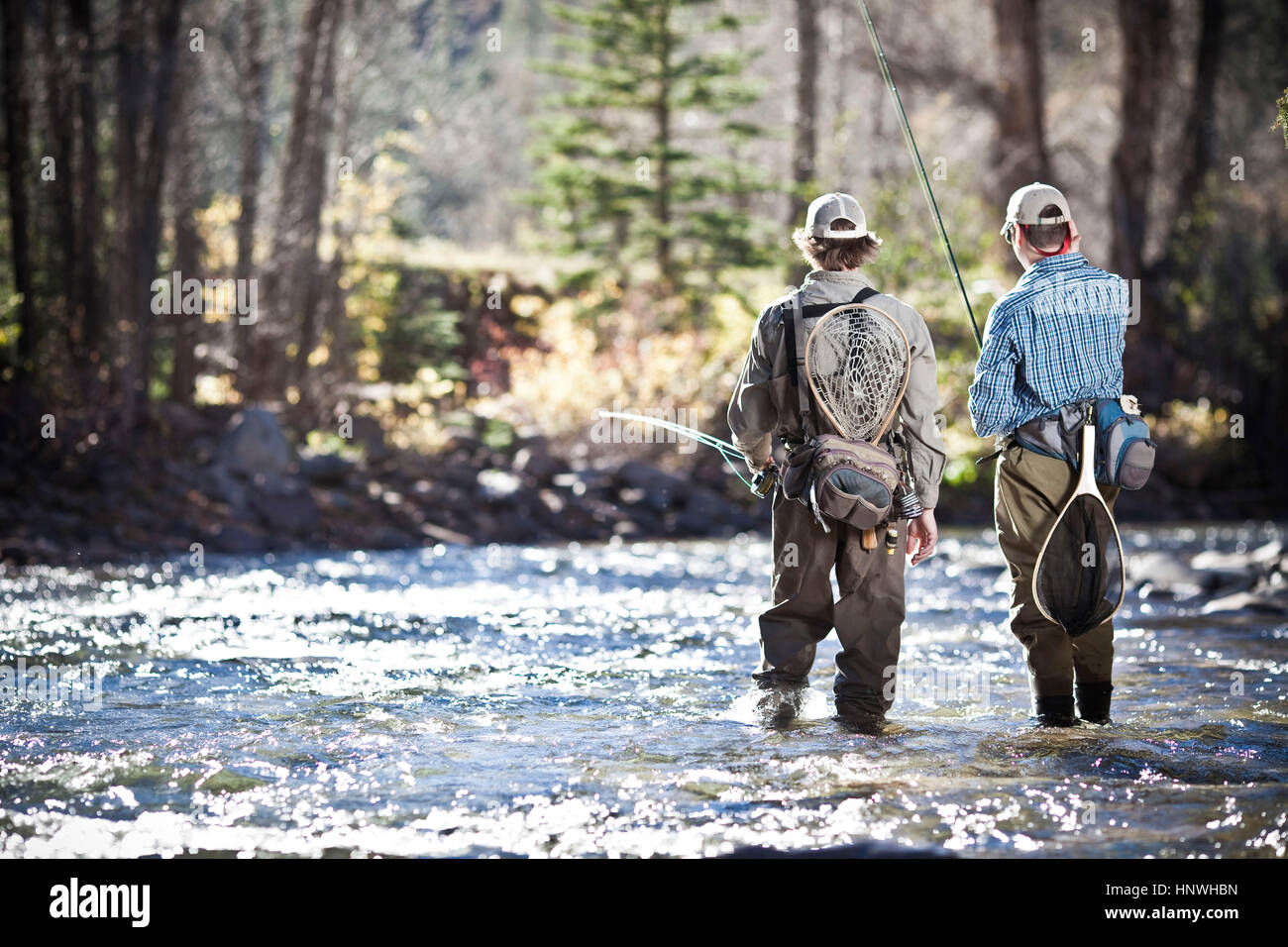 Fishermen ankle deep in river fly fishing, Colorado, USA Stock Photo