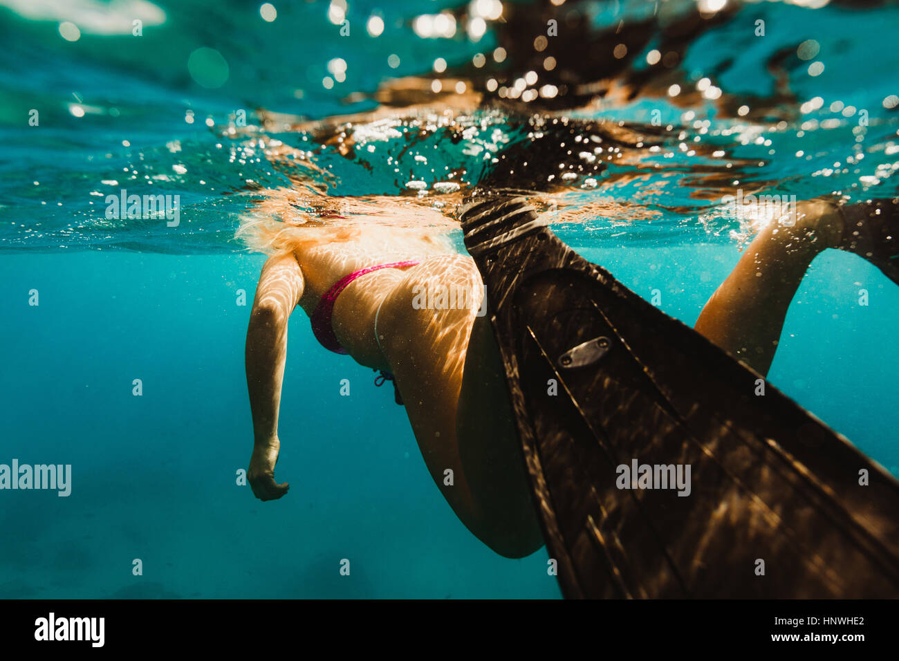 Underwater view of woman wearing flipper swimming, Oahu, Hawaii, USA Stock Photo