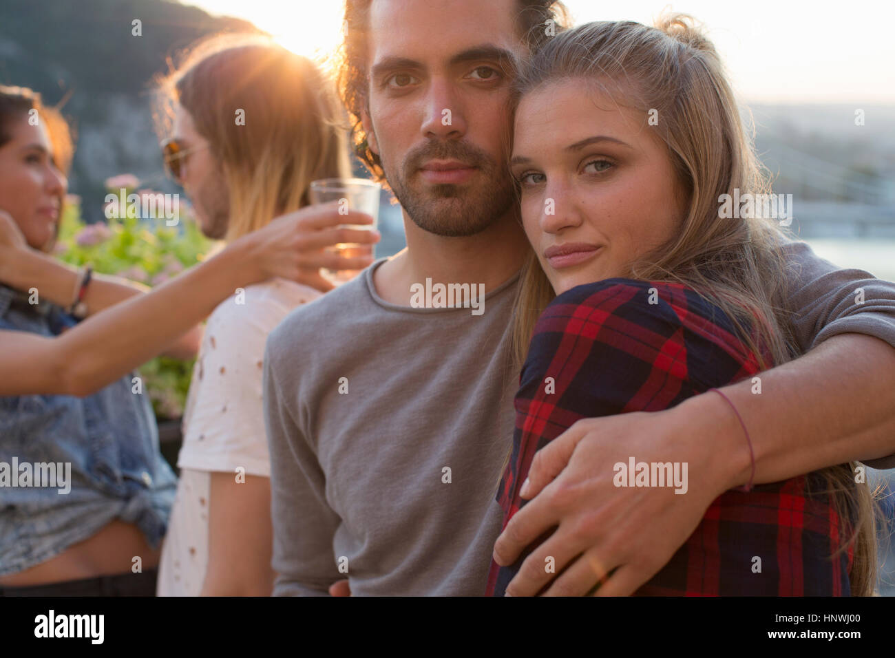 Portrait of couple at waterfront roof terrace party, Budapest, Hungary Stock Photo