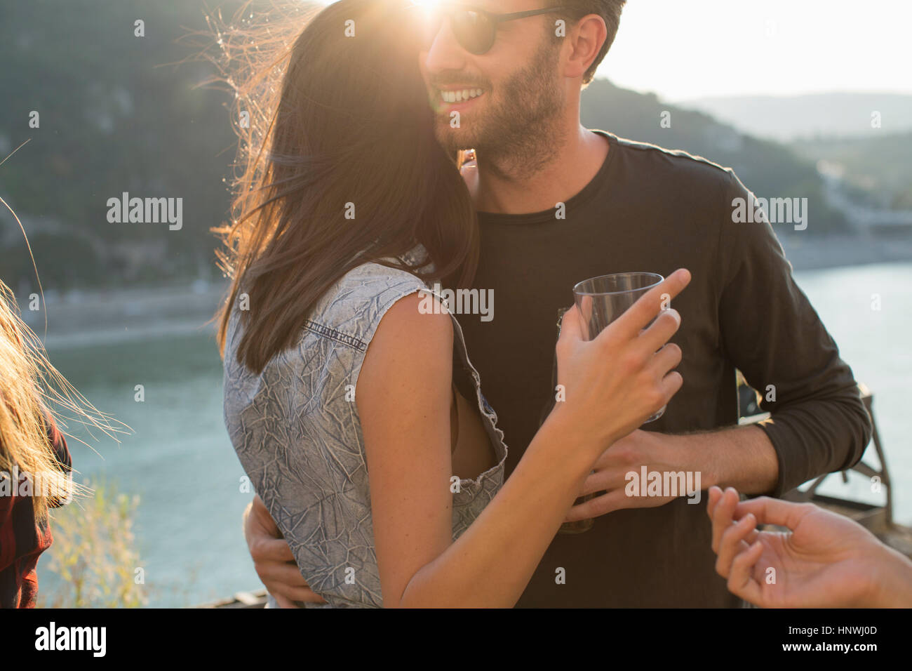 Romantic young couple at roof terrace waterfront party, Budapest, Hungary Stock Photo