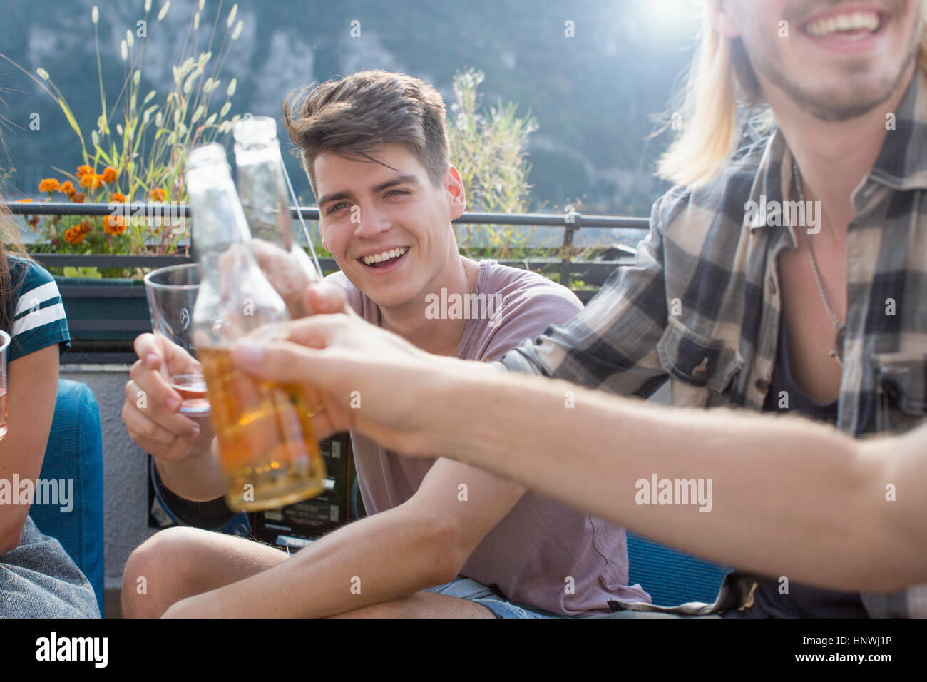 Adult friends raising a toast at roof terrace party Stock Photo