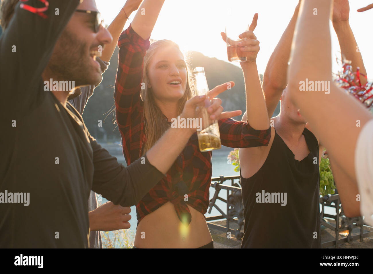 Adult friends dancing at waterfront roof terrace party, Budapest, Hungary Stock Photo
