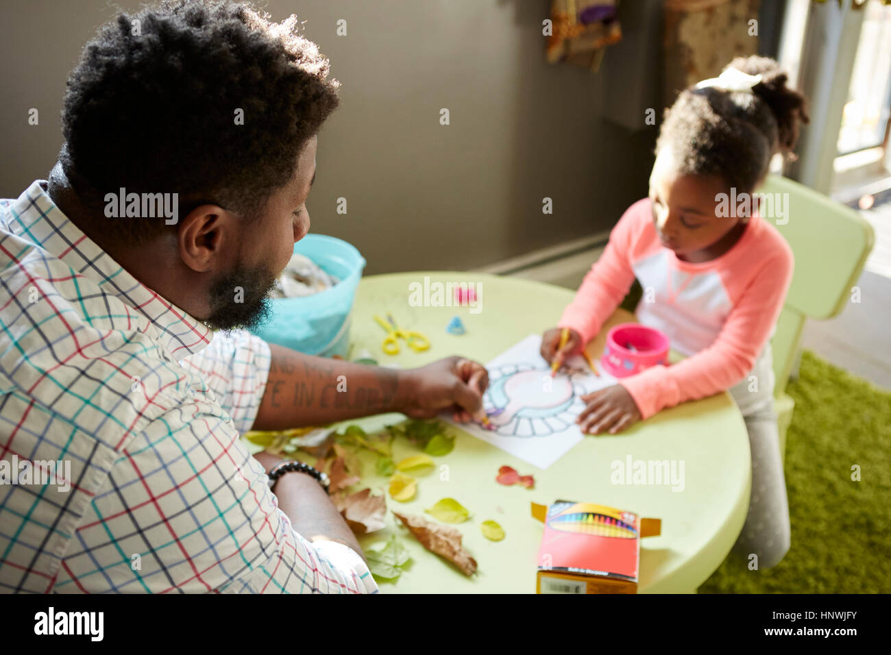 Father and daughter enjoying colouring in activity Stock Photo Alamy