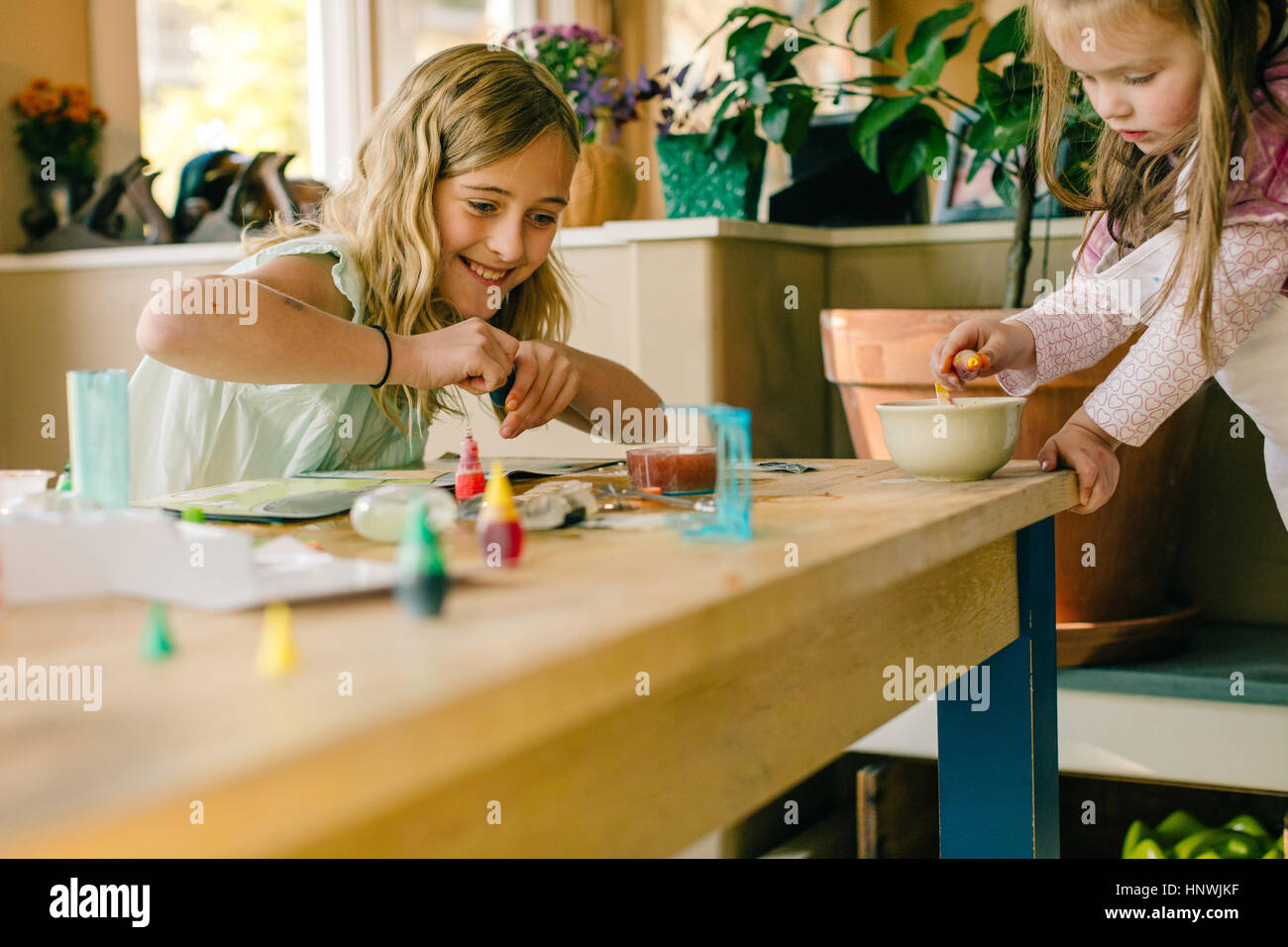 Two girls doing science experiment at table Stock Photo