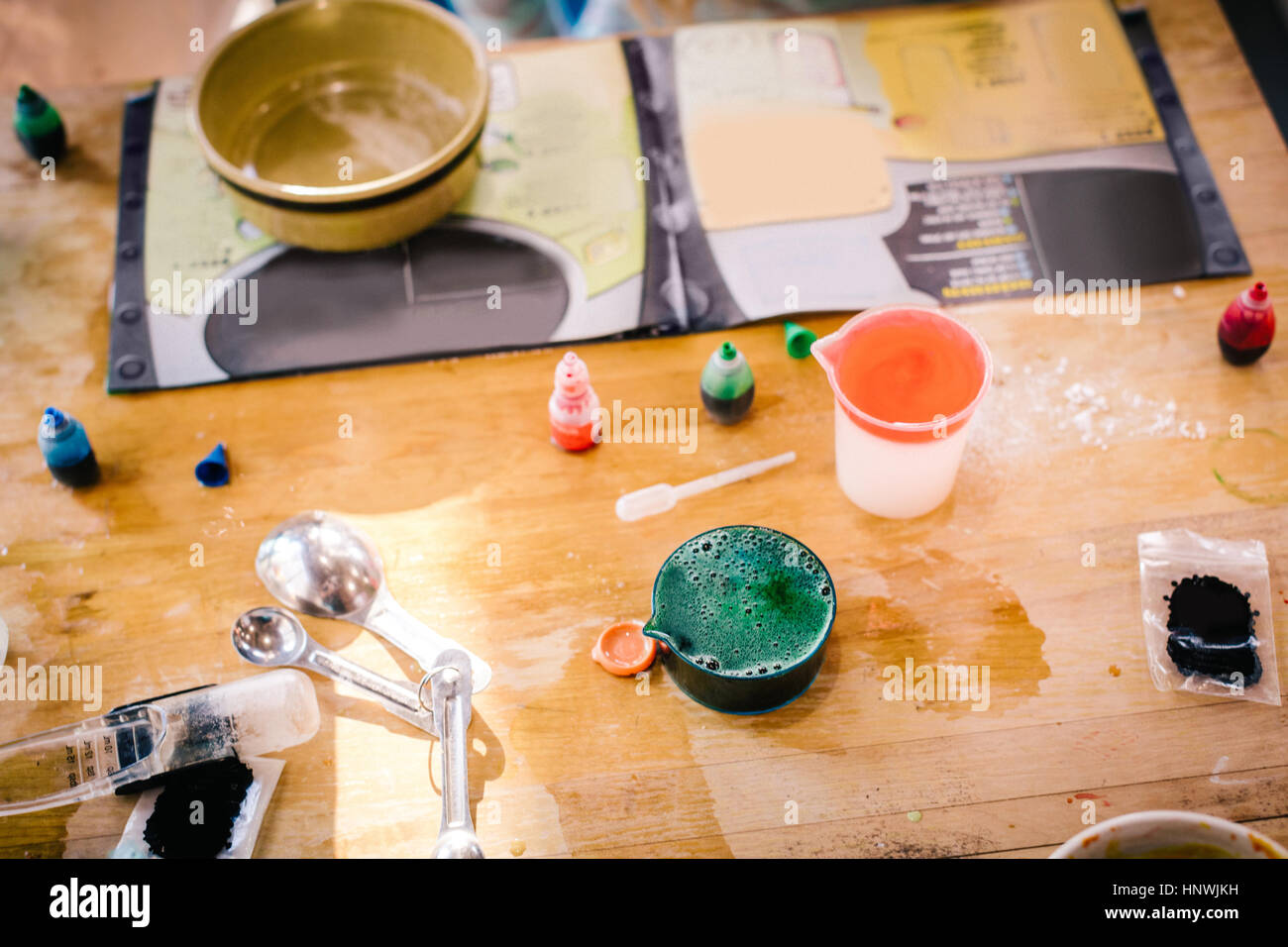 Child's messy chemistry set science experiment on table with instructions Stock Photo