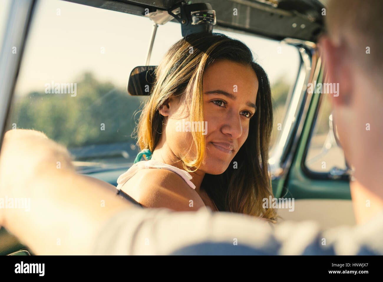 Over shoulder view of road trip couple in parked truck Stock Photo