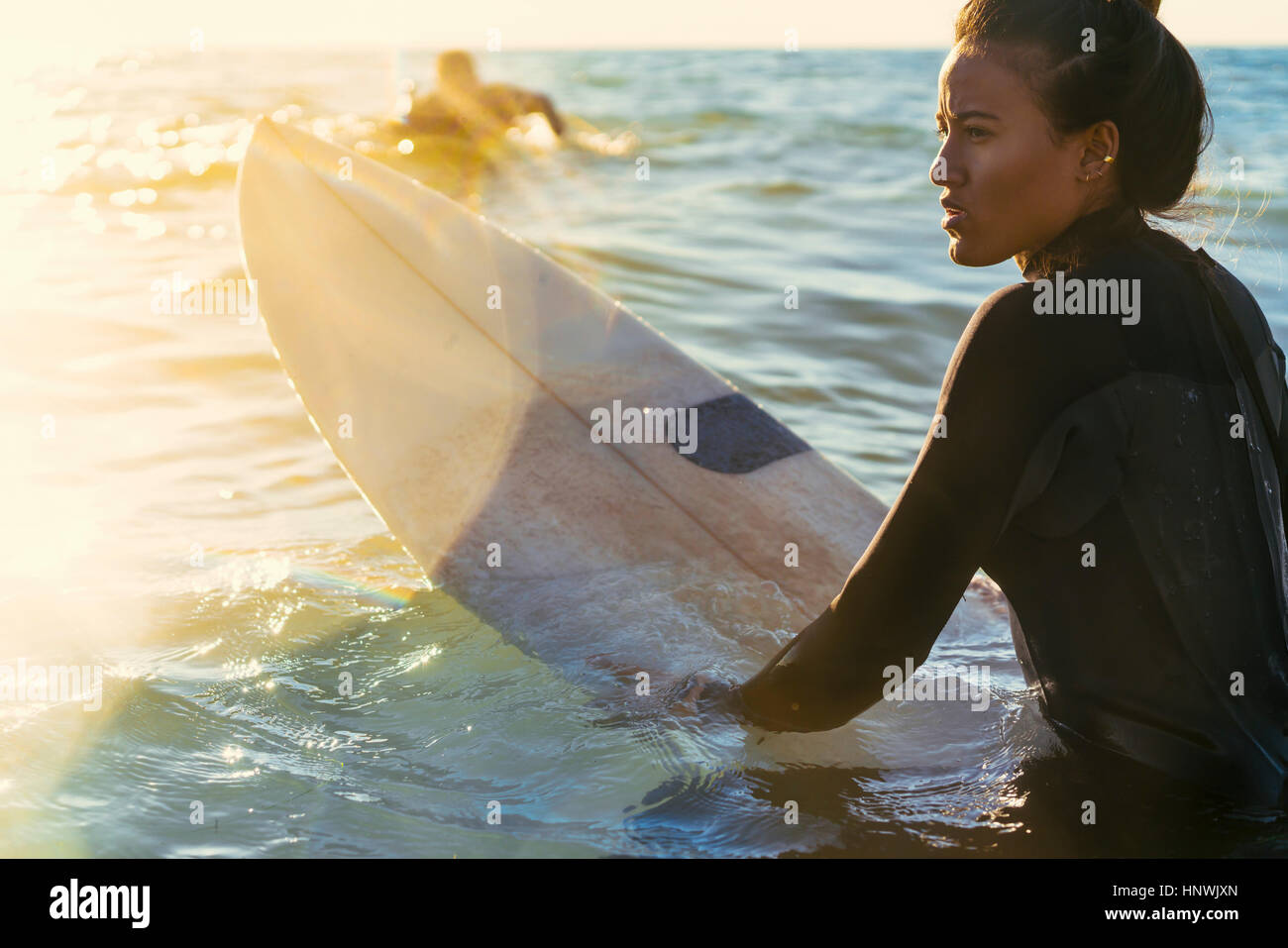 Young female surfer wading in sea, Newport Beach, California, USA Stock Photo