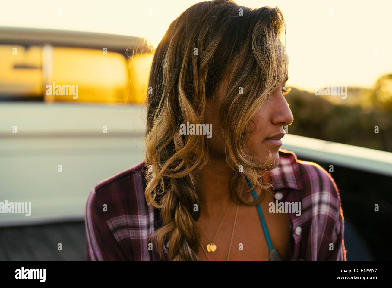 Young woman looking sideways from back of pickup truck at Newport Beach, California, USA Stock Photo