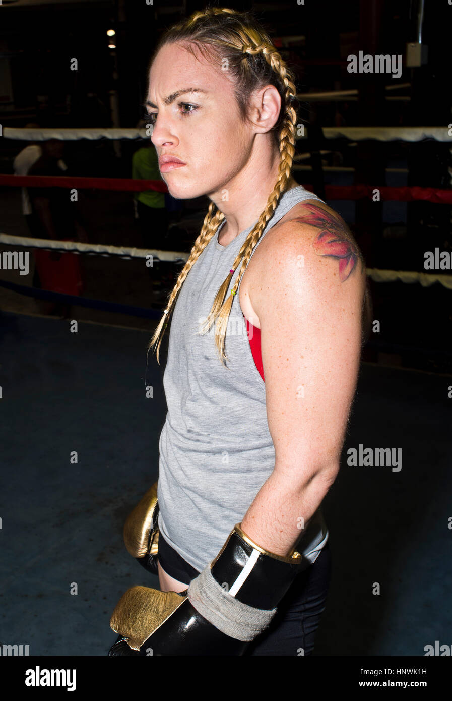 Aggressive female boxer in boxing ring Stock Photo
