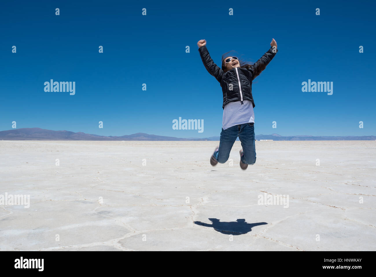 Child jump on Salinas Grandes (Argentina) Stock Photo