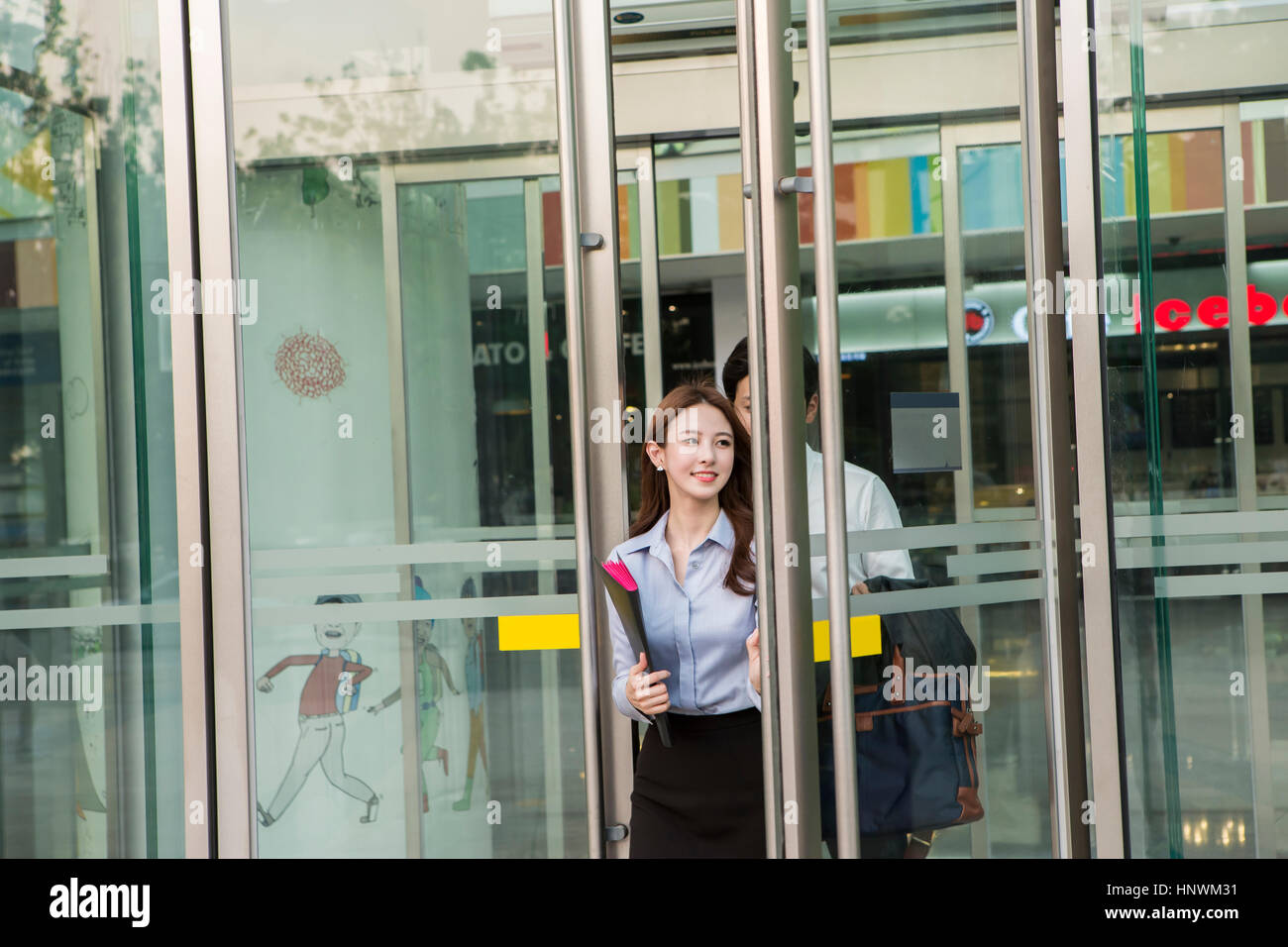 Young smiling business people at revolving door Stock Photo