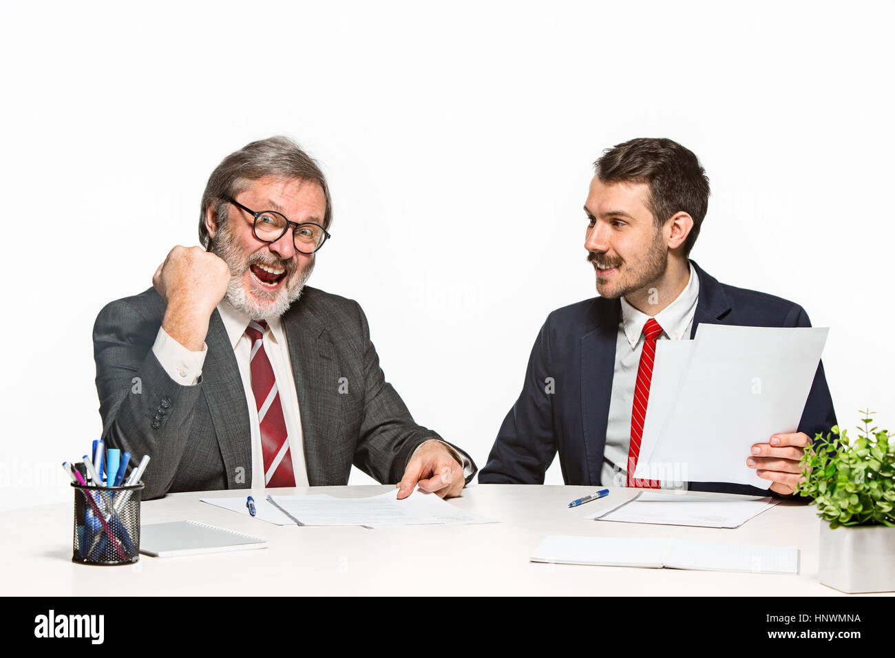 Two Team Members The two colleagues working together at office on white background Stock ...