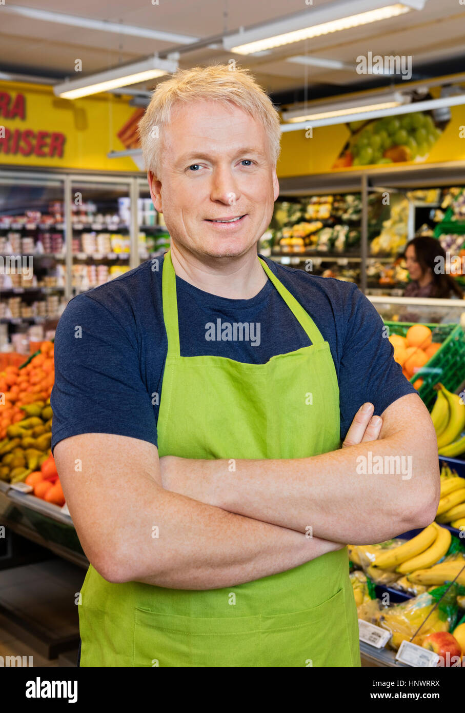 Salesman With Hands Folded Standing In Grocery Store Stock Photo Alamy