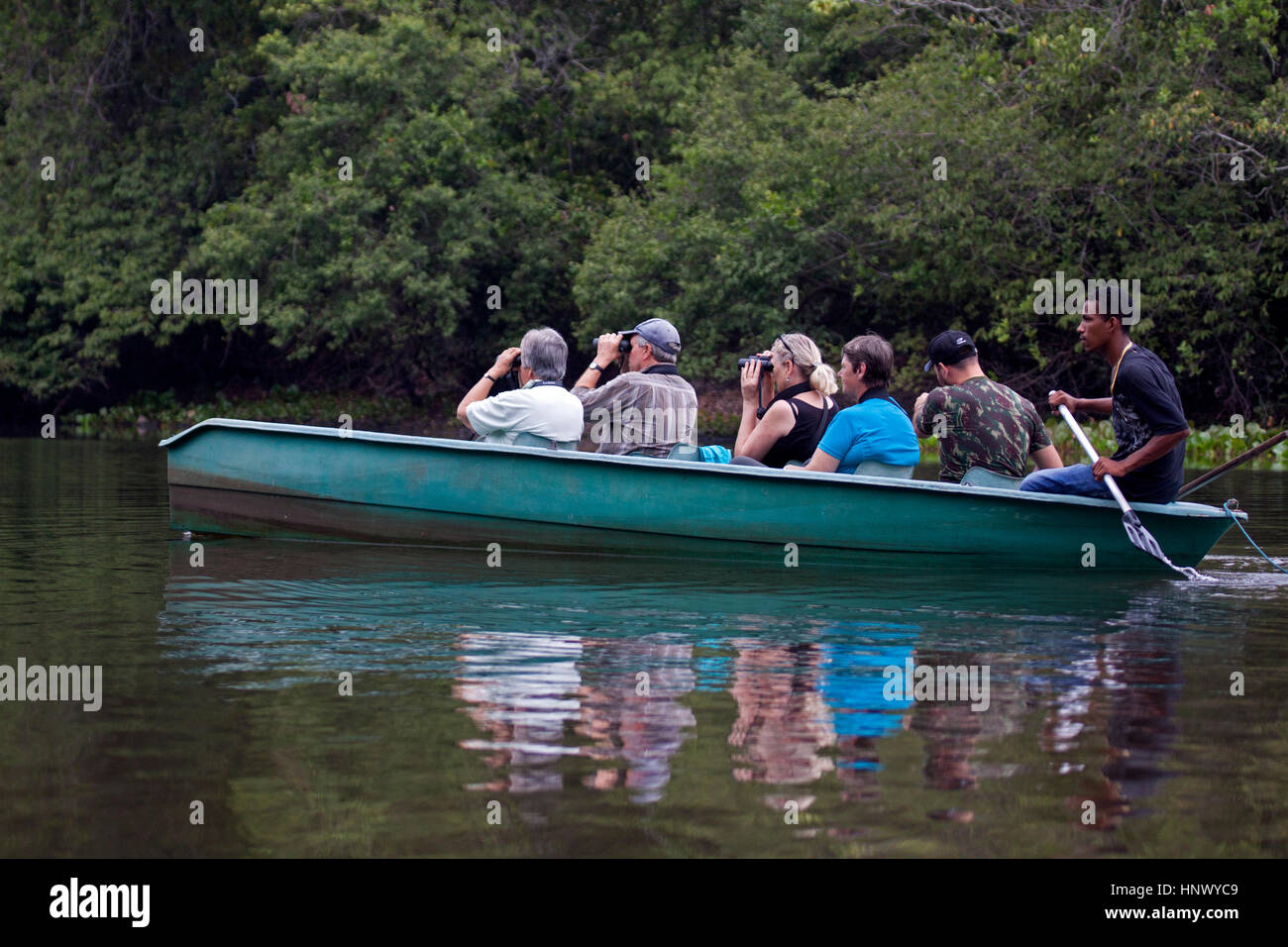 Birdwatchers on observation trip on river in Brazil Stock Photo